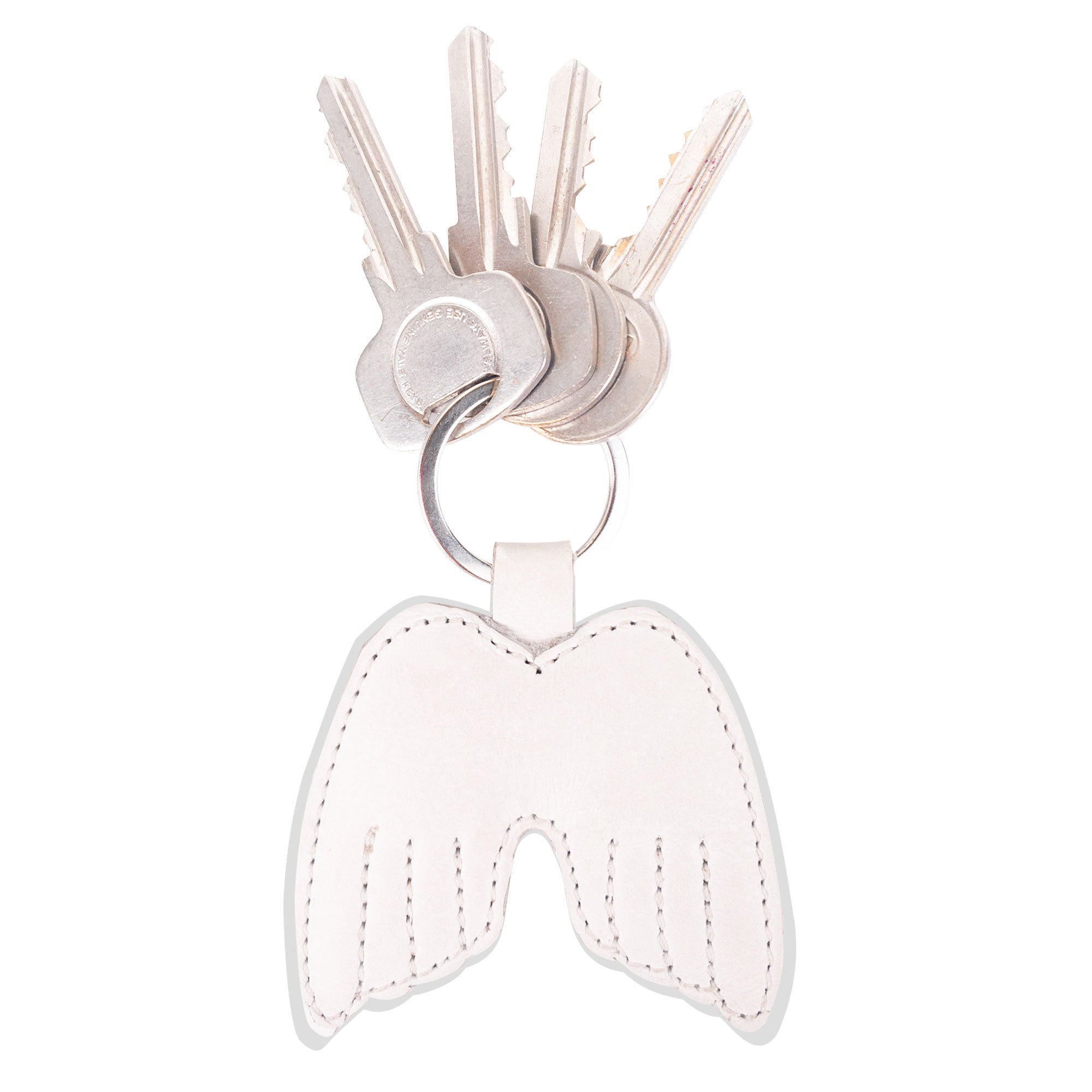 Angel Wings Keychain by Hide & Drink featuring a stylish design with keys attached, crafted from Full Grain Leather. This key ring holder embodies peace and elegance, showcasing small batch production techniques. Handmade in La Antigua Guatemala & Oaxaca Mexico, it is hand-cut, hand-sewn, and fire branded, reflecting true artisan craftsmanship.
