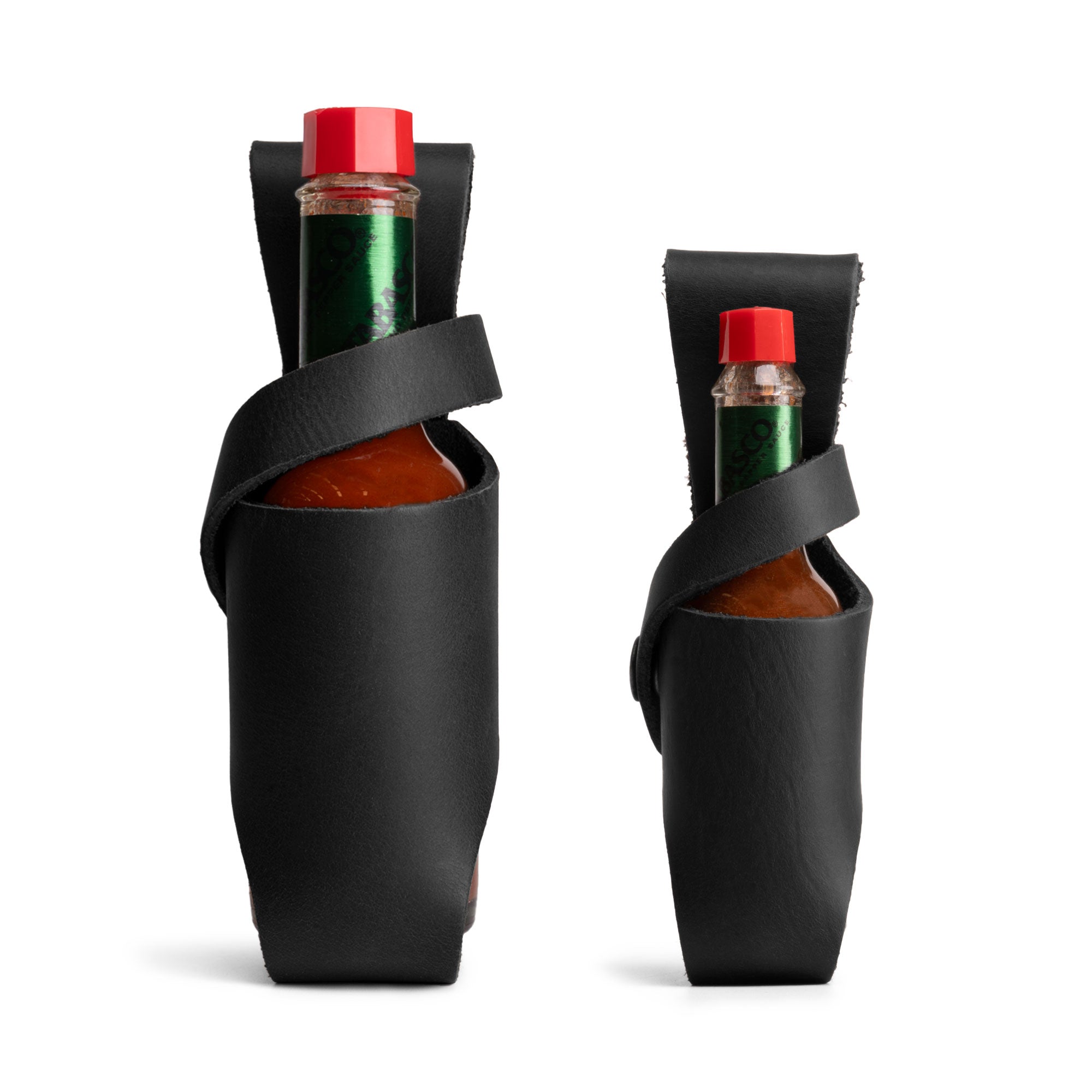 Hide & Drink Tabasco Holsters (2pk) illustrating stylish holders for hot sauce bottles sized 5oz and 2oz. Perfect for brands like Tabasco and Cholulah, made from durable full grain leather, these products showcase artisan care and small batch production from La Antigua Guatemala & Oaxaca Mexico.