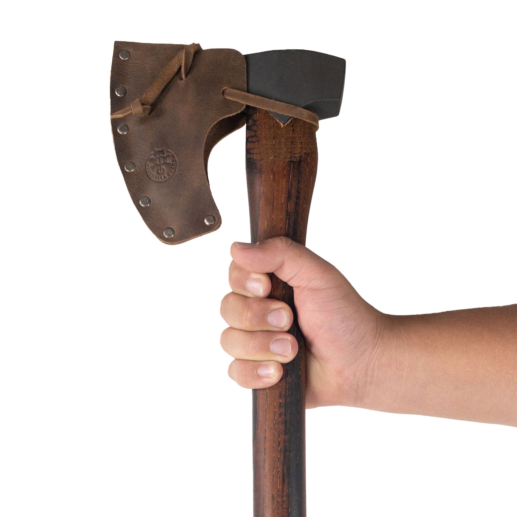 A person holding the Axe Head Sheath with String by Valhalla Gear, emphasizing its practicality. Handmade in Guatemala, this functional sheath is perfect for outdoor enthusiasts and bikers alike, adding a touch of sophistication to any motorcycle tool bag.