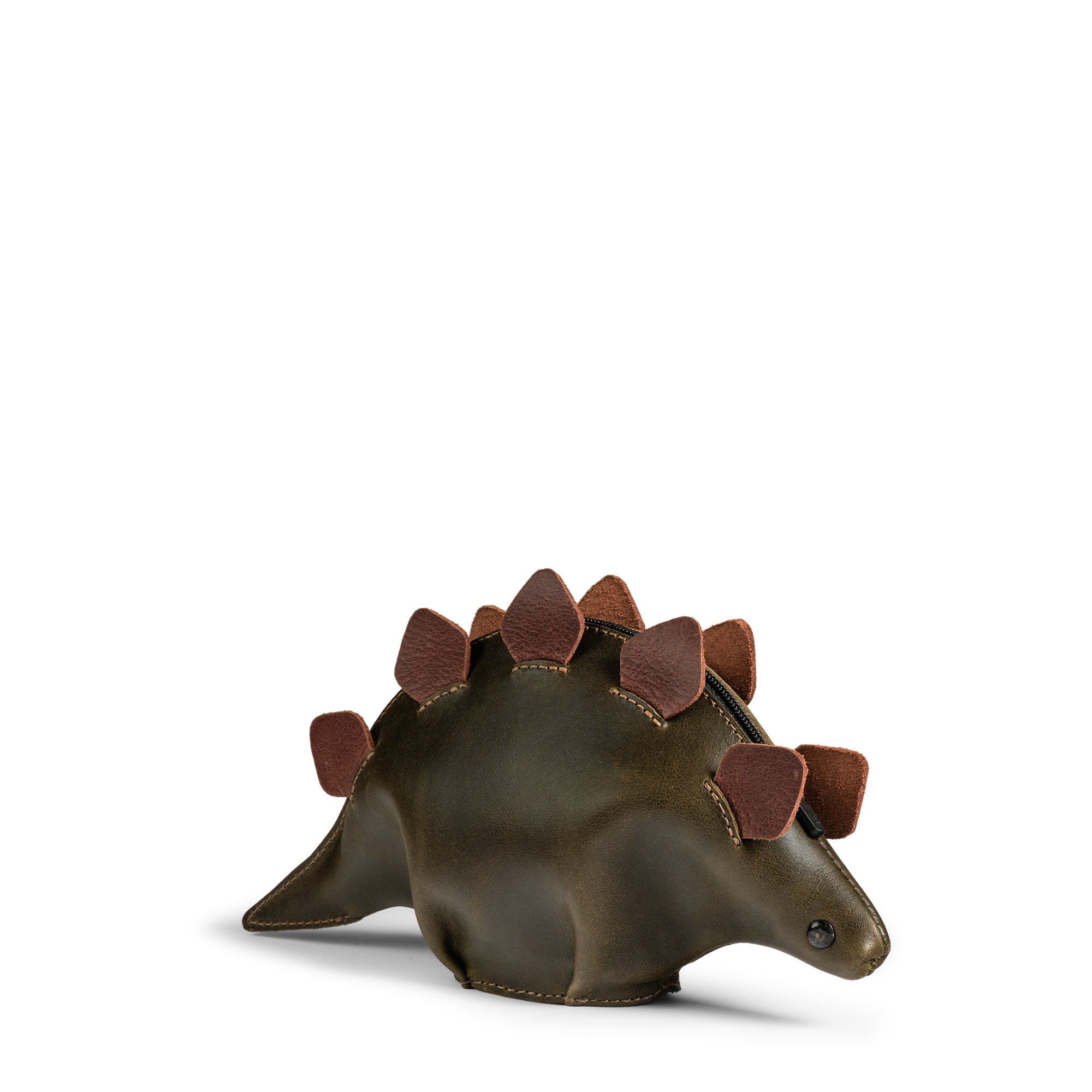 The Leather Dinosaur Stegosaurus Pouch by Tudi Frudi showcases a unique dino-shaped design, perfect as a small accessory case, cable organizer, or zippered cash holder wallet for coins. This handmade pouch, crafted using small batch production techniques in La Antigua Guatemala and Oaxaca Mexico, is ideal for both men and women.
