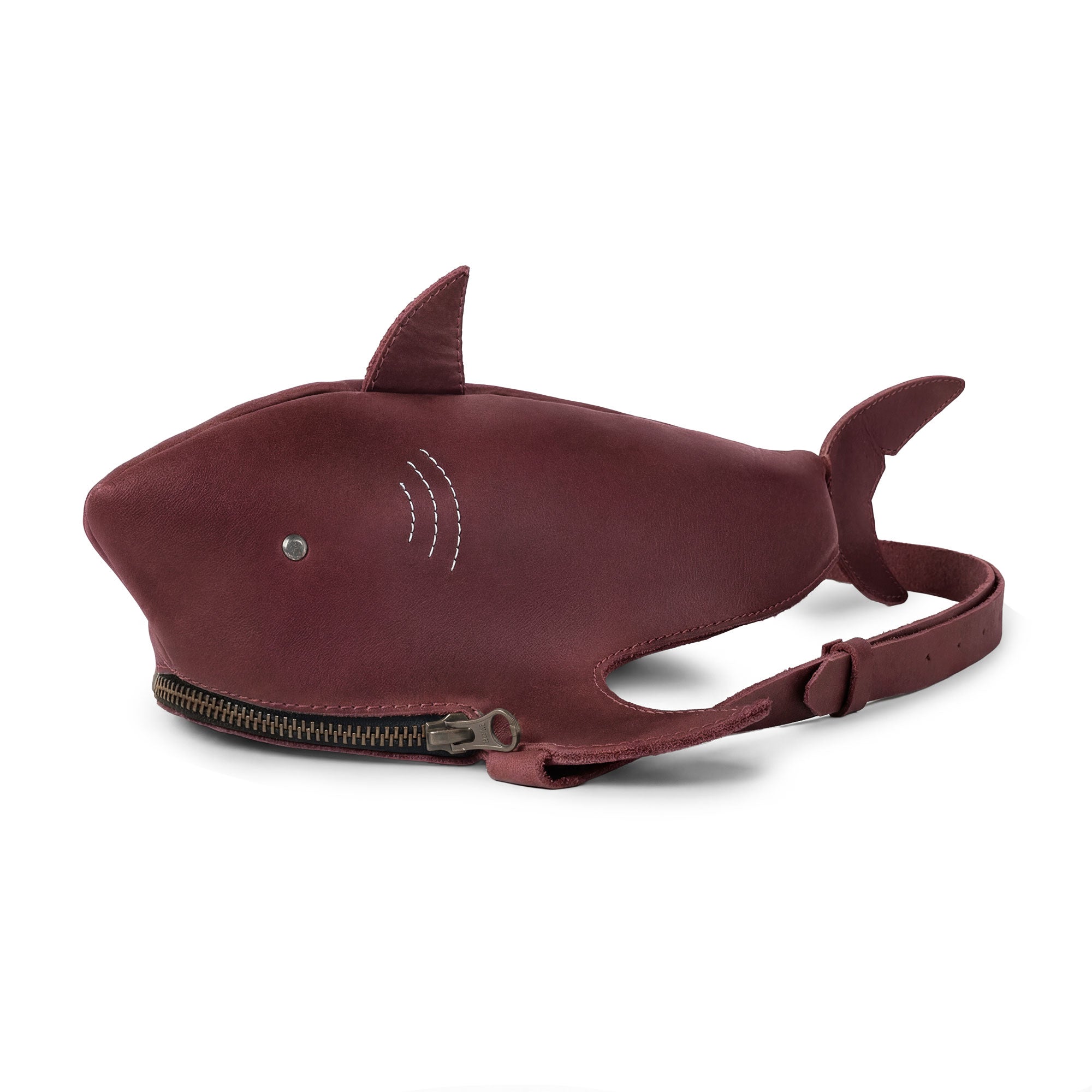 Stylish Shark-Shaped Shoulder Bag by Tudi Frudi made from Full Grain Leather, featuring a unique design and adjustable strap. This versatile bag can be worn as a crossbody or messenger bag, ideal for anyone who appreciates artisan craftsmanship and small batch production, handmade in La Antigua Guatemala.