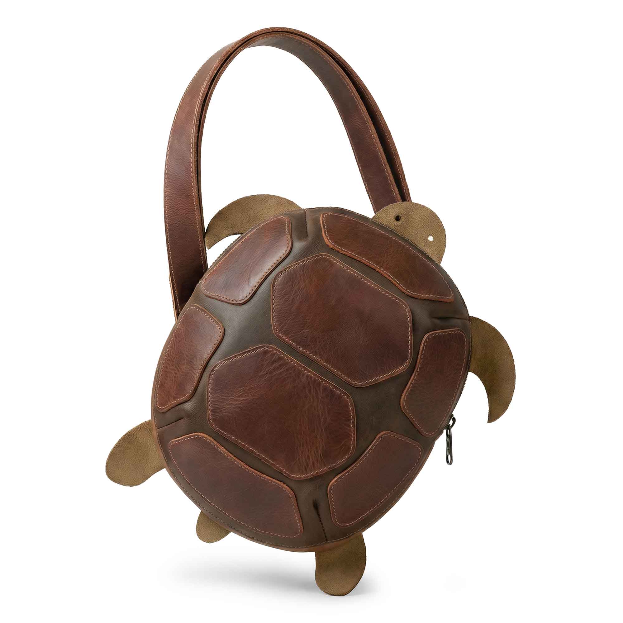 Leather Turtle-Shaped Crossbody Bag by Hide & Play featuring a unique turtle design, perfect as a messenger bag or shoulder bag. This zippered sling bag is ideal for travel and showcases full grain leather craftsmanship. Handmade in La Antigua Guatemala & Oaxaca Mexico, this small batch production piece is hand cut, hand sewn, and fire branded.