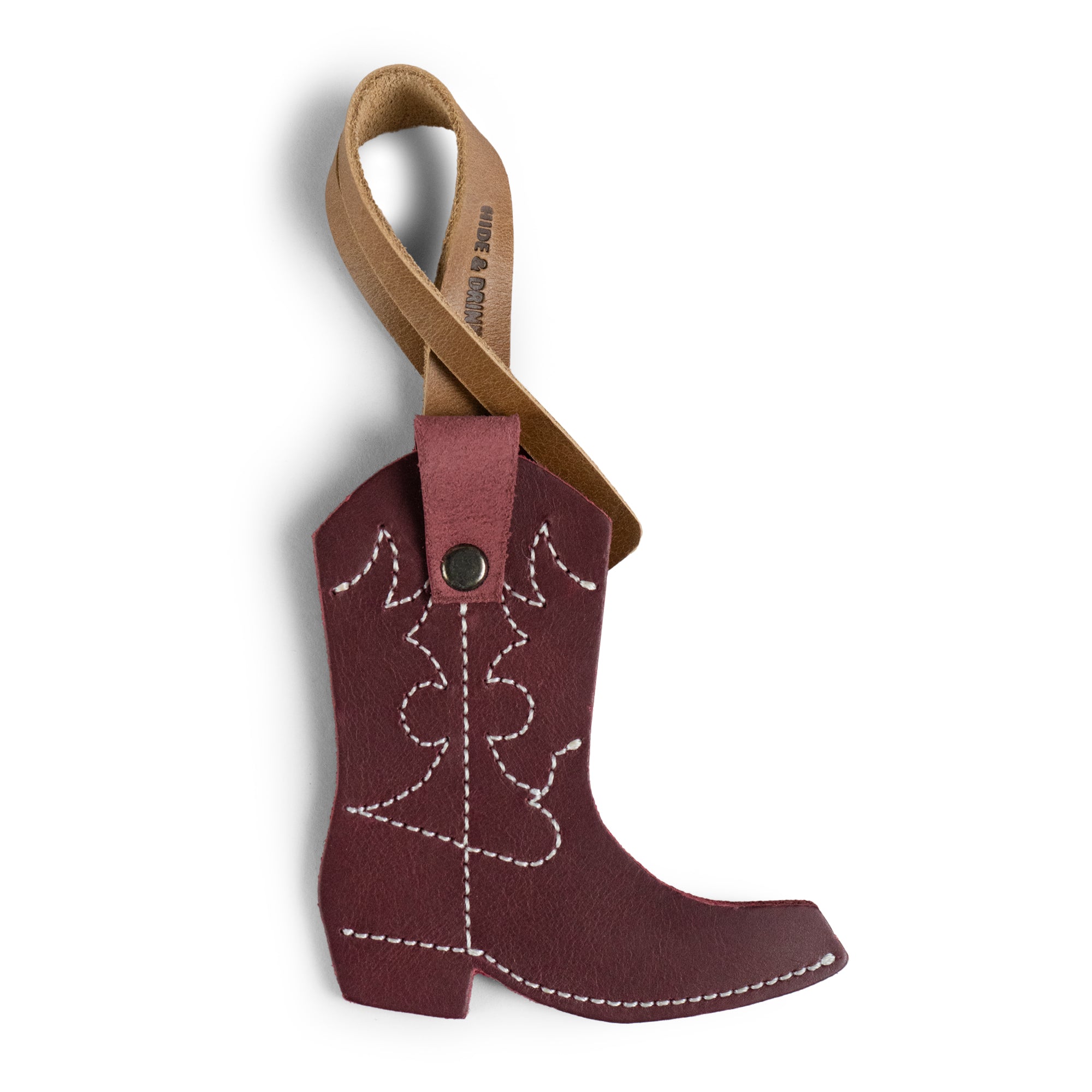 Introducing the Western Boot Bag Charm by Hide & Drink, this artisan charm features a unique cowboy boot design crafted from full grain leather, perfect as a purse charm for totes and backpacks. Handmade in La Antigua, Guatemala & Oaxaca, Mexico, it combines small batch production and meticulous fire branded craftsmanship. Elevate your style with this elegant ornament for women!