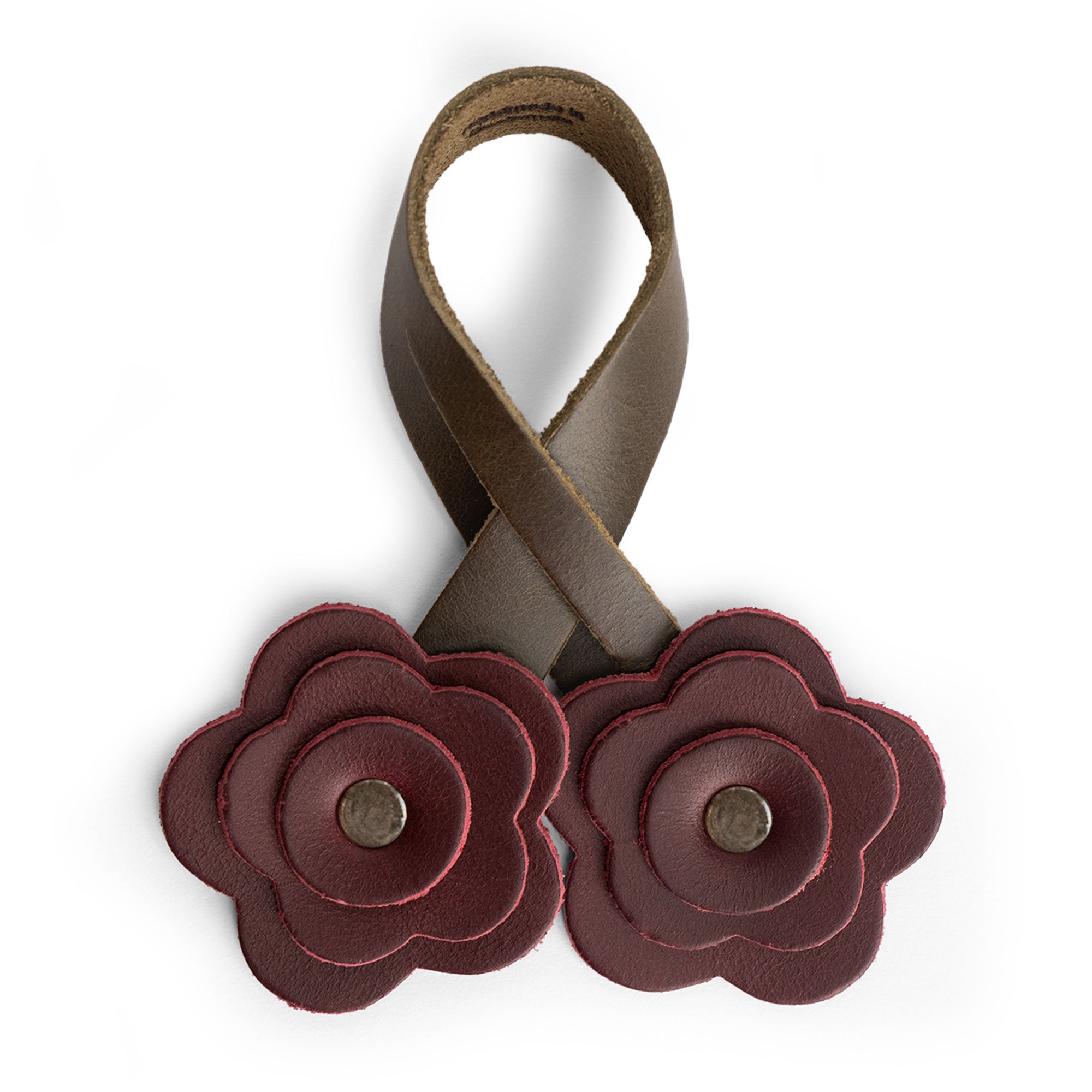 Close-up of the dark red flower design of the Rose Bag Ornament by Hide & Drink, emphasizing its Full Grain Leather quality. A lovely accessory for bags, bringing a cute charm to your style.