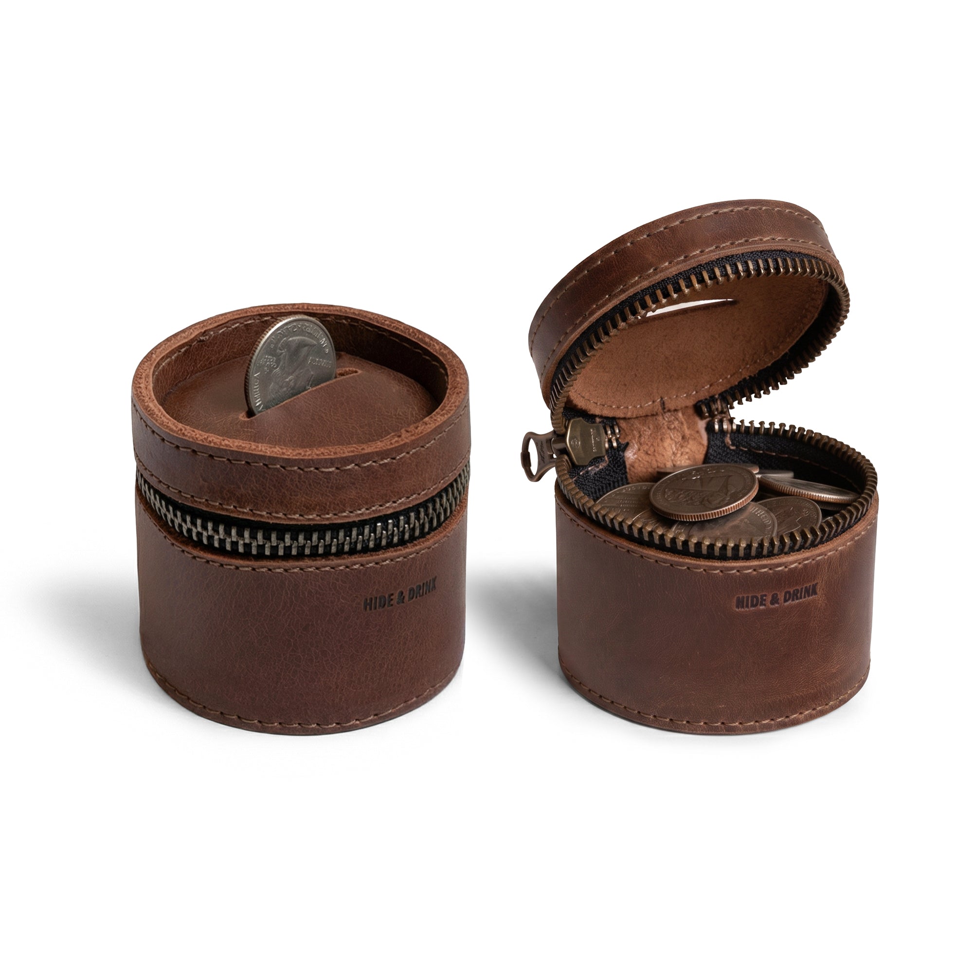 The Bucket Coin Release by Hide & Drink is a stylish money box, featuring a full grain leather design in a zippered pouch shape. This artisan-crafted piggy bank bucket is handmade in La Antigua Guatemala & Oaxaca Mexico, with meticulous hand-cut and hand-sewn detailing, making it an elegant cash organizer and coin case.