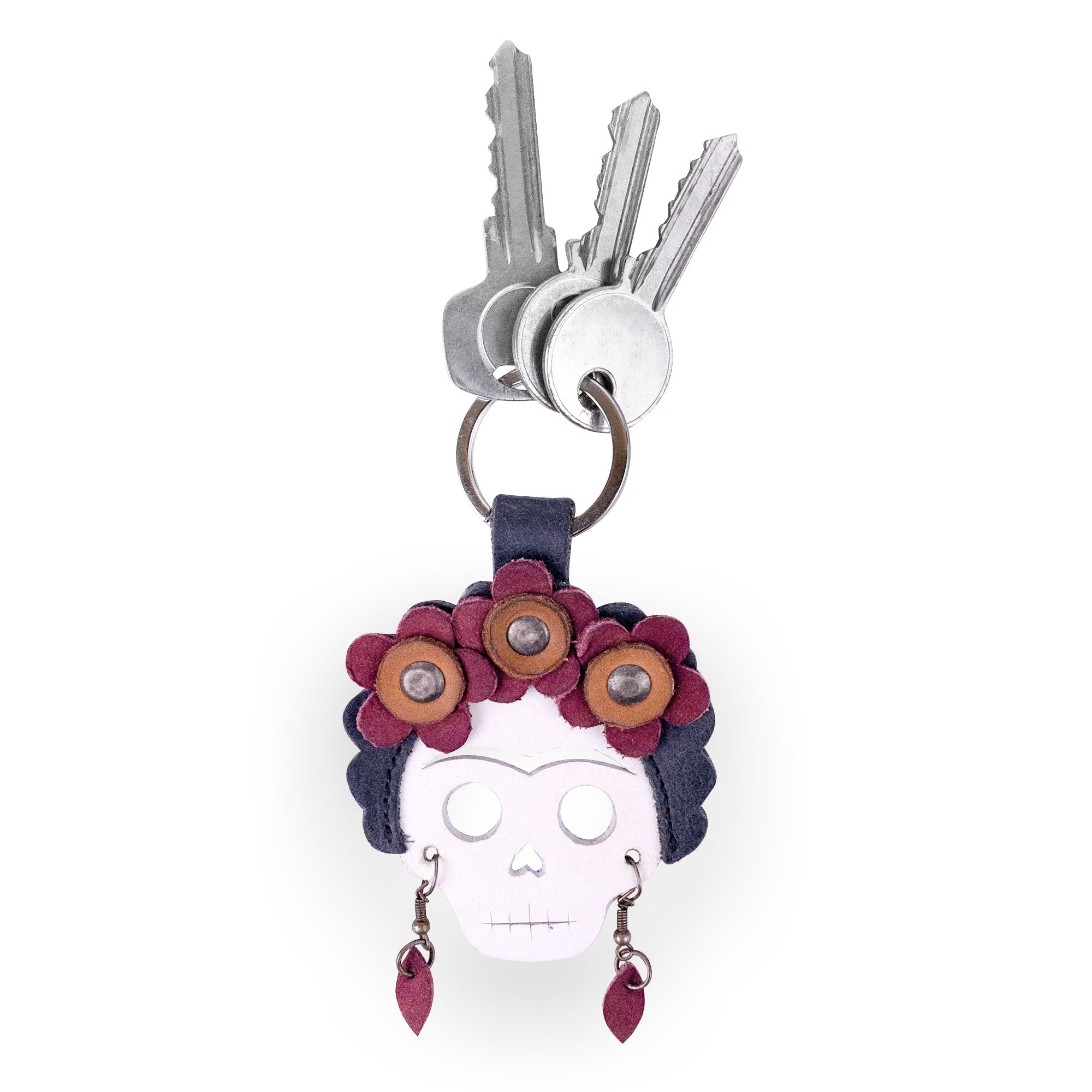 Lady Skull Leather Keychain by Hide & Drink featuring a colorful Dia De Los Muertos design, perfect as a keyring or key organizer. This small batch accessory showcases Mexican culture, ideal for travel. Made from durable Full Grain Leather, it's hand cut and sewn by artisans in La Antigua Guatemala and Oaxaca Mexico.