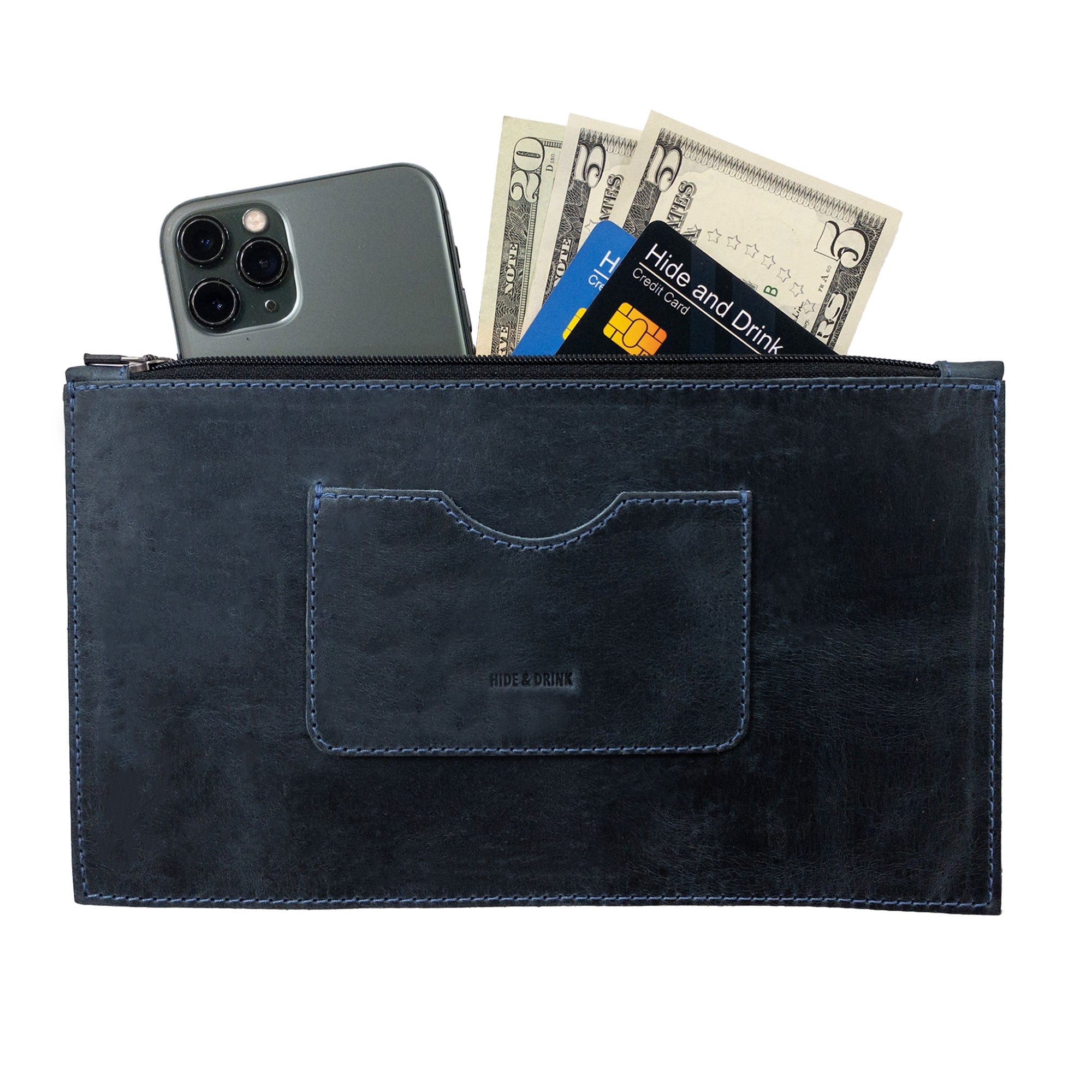 A dark brown rectangular zippered handbag by Hide & Drink displaying cash and a smartphone, tailored for women. This full grain leather female purse features a card slot and highlights the careful craftsmanship in artisan production methods, handcrafted in La Antigua Guatemala & Oaxaca Mexico.