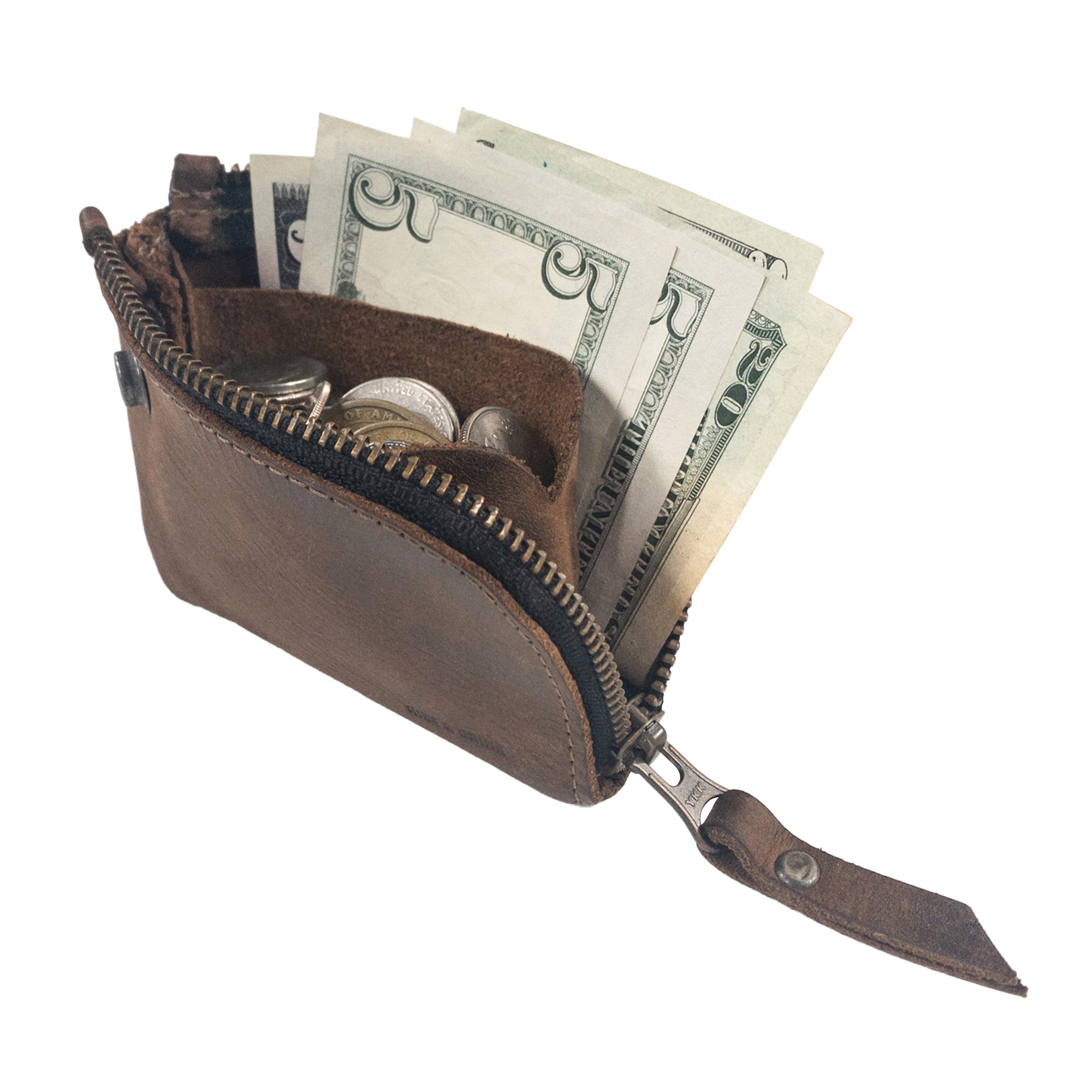 Lion's Mane Zippered Wallet by Hide & Drink filled with folded bills and coins. This mini wallet is an essential travel companion, combining style and functionality with its full grain leather construction.