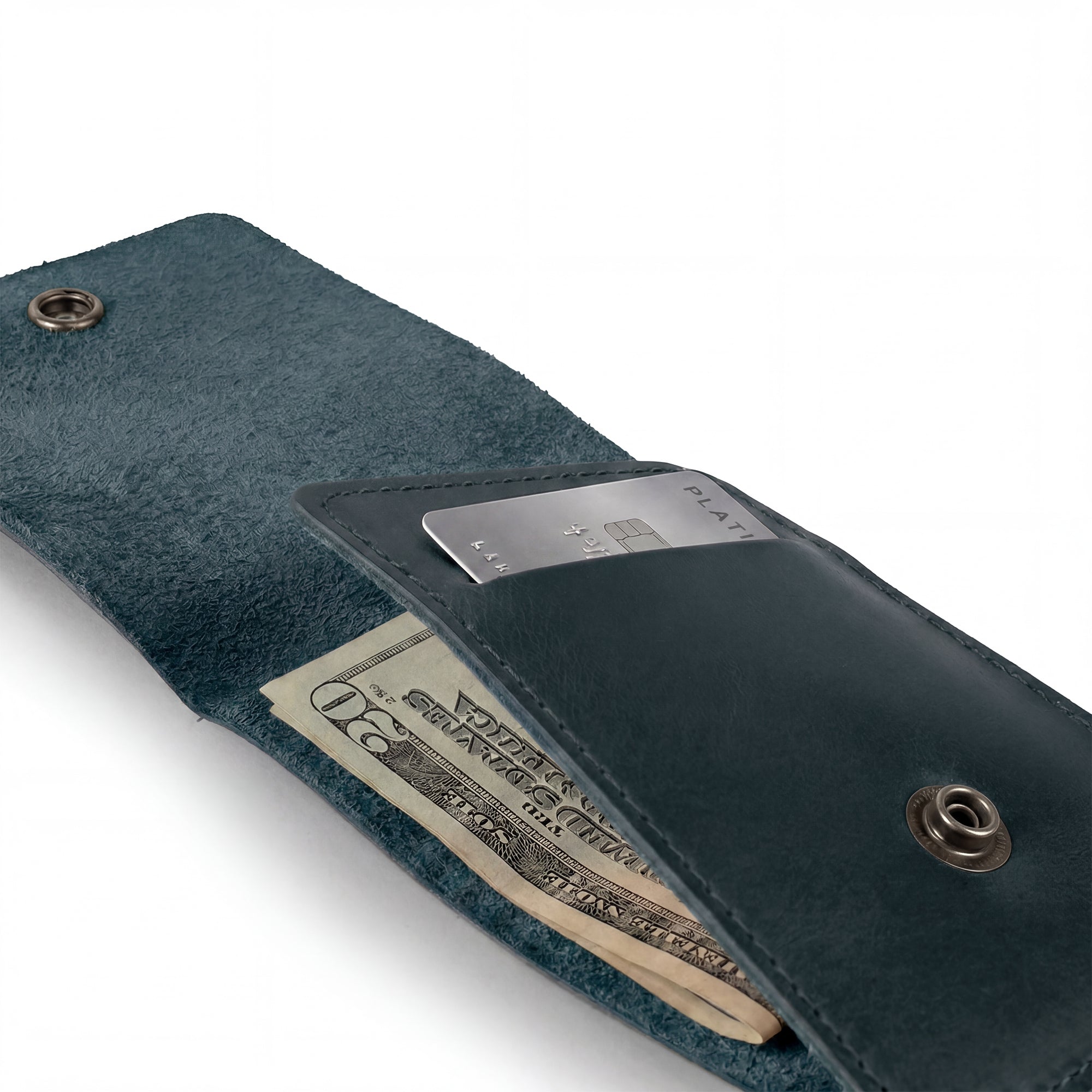 Back view of the blue Vertical Wallet by Hide & Drink featuring the embossed logo. This Vertical Front Pocket Wallet with Card Slot merges fashion with function, enabling compact storage for bills and cards, crafted from full grain leather utilizing small batch production techniques, hand cut, and hand sewn with fire branding. Handmade in La Antigua Guatemala & Oaxaca Mexico.
