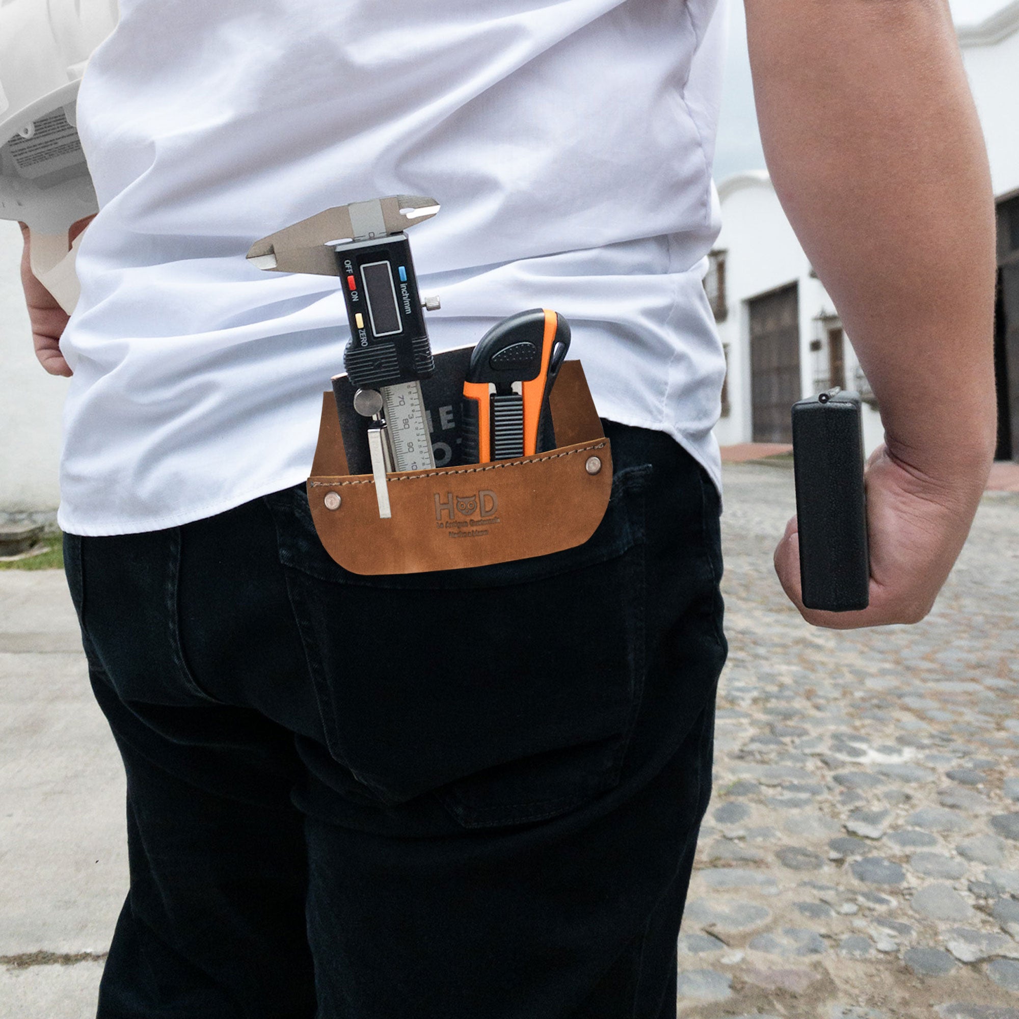Lifestyle shot of Hide & Drink Leather Work Pocket in use, showing its practical application for holding tools and pens. A perfect blend of style and function in this Leather Work Pocket designed for job tools and work essentials.
