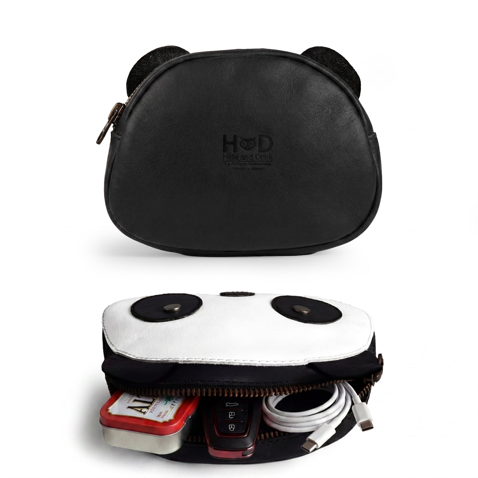 Front view of the Panda Head Shape Wallet by Hide & Drink, highlighting its playful panda face. This wallet is ideal for cash, cables, cards, and travel accessories and is crafted from Full Grain Leather, featuring hand cut and hand sewn designs, fire branded for quality, made in La Antigua Guatemala & Oaxaca Mexico.