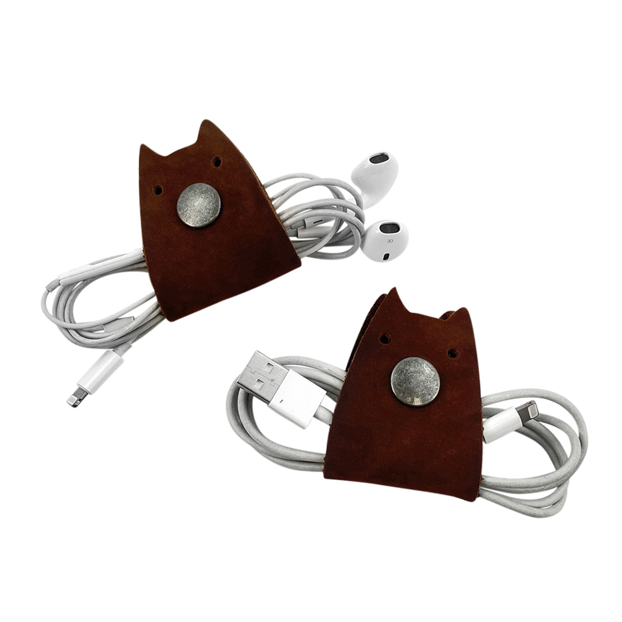 Brown leather Taco Dog Cat Cord Keeper (2 Pack) displayed with cables wrapped for convenience. Helps manage your earbuds, chargers, and headphones effectively. Artisan crafted in La Antigua Guatemala & Oaxaca Mexico.