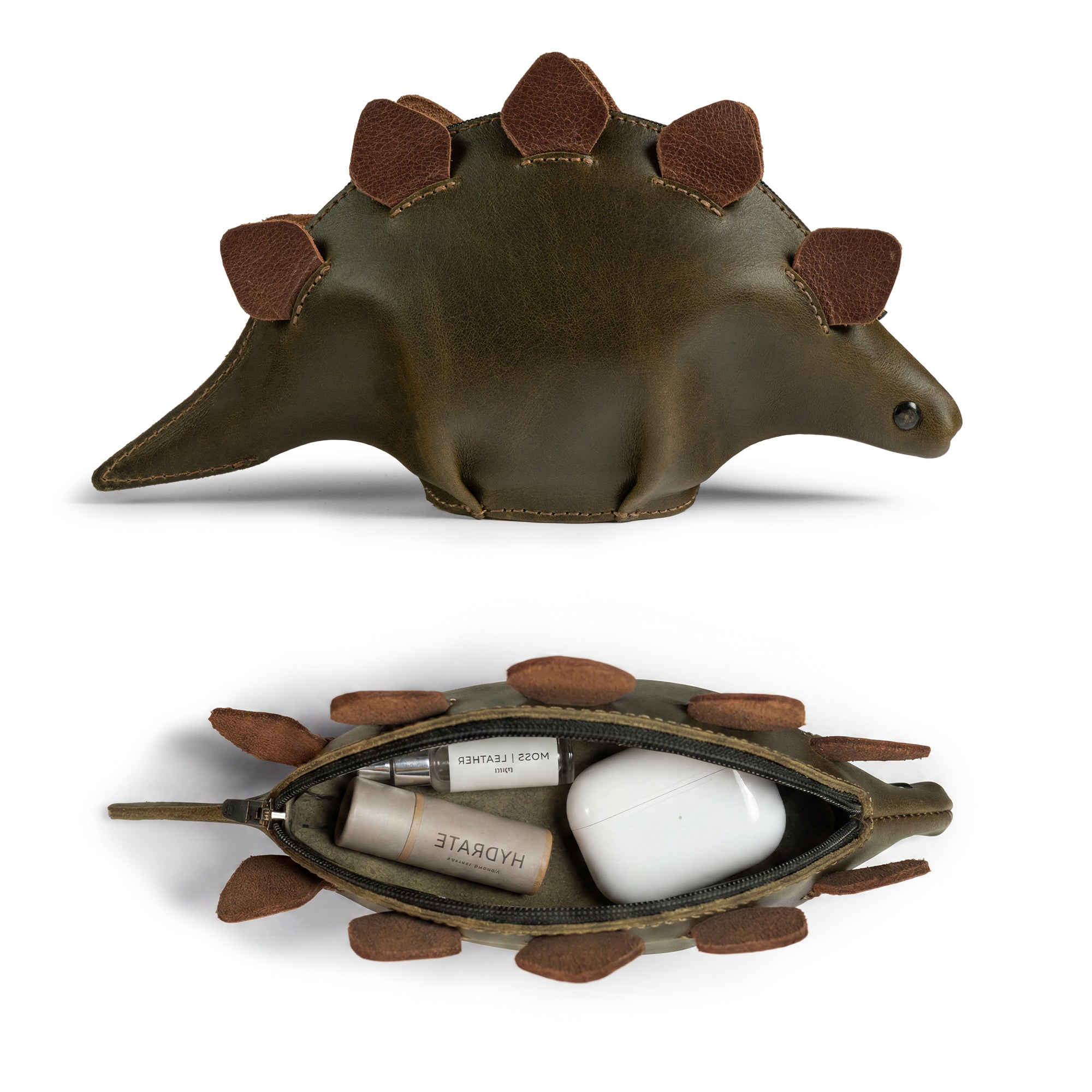 Open view of the Leather Dinosaur Stegosaurus Pouch by Tudi Frudi, highlighting its functionality as a change purse and organizer for cosmetics. This artisan product features a dino-shaped design, perfect for storing small items, reflecting small batch production and hand-cut details from La Antigua Guatemala and Oaxaca, Mexico.