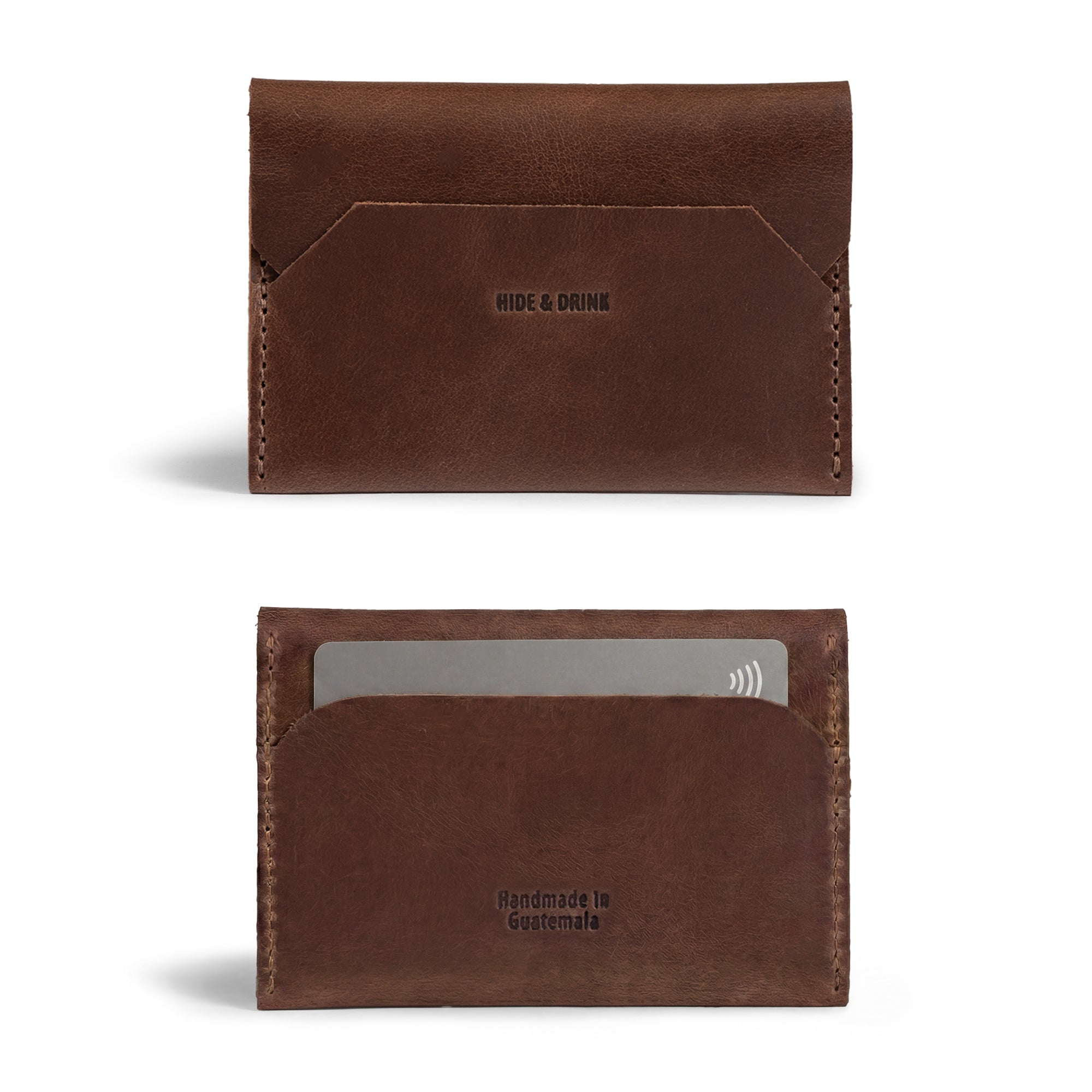 Close-up of the Enfold Card Wallet from Hide & Drink presenting a classic leather card wallet. This design serves as a compact credit card holder for men and a minimalist thin business card organizer, perfect for cash storage with a vintage case for bills. Crafted from full grain leather, it boasts small batch production, hand cut, and hand sewn details, featuring fire branding that captures the artisan quality of handmade in La Antigua Guatemala and Oaxaca Mexico.