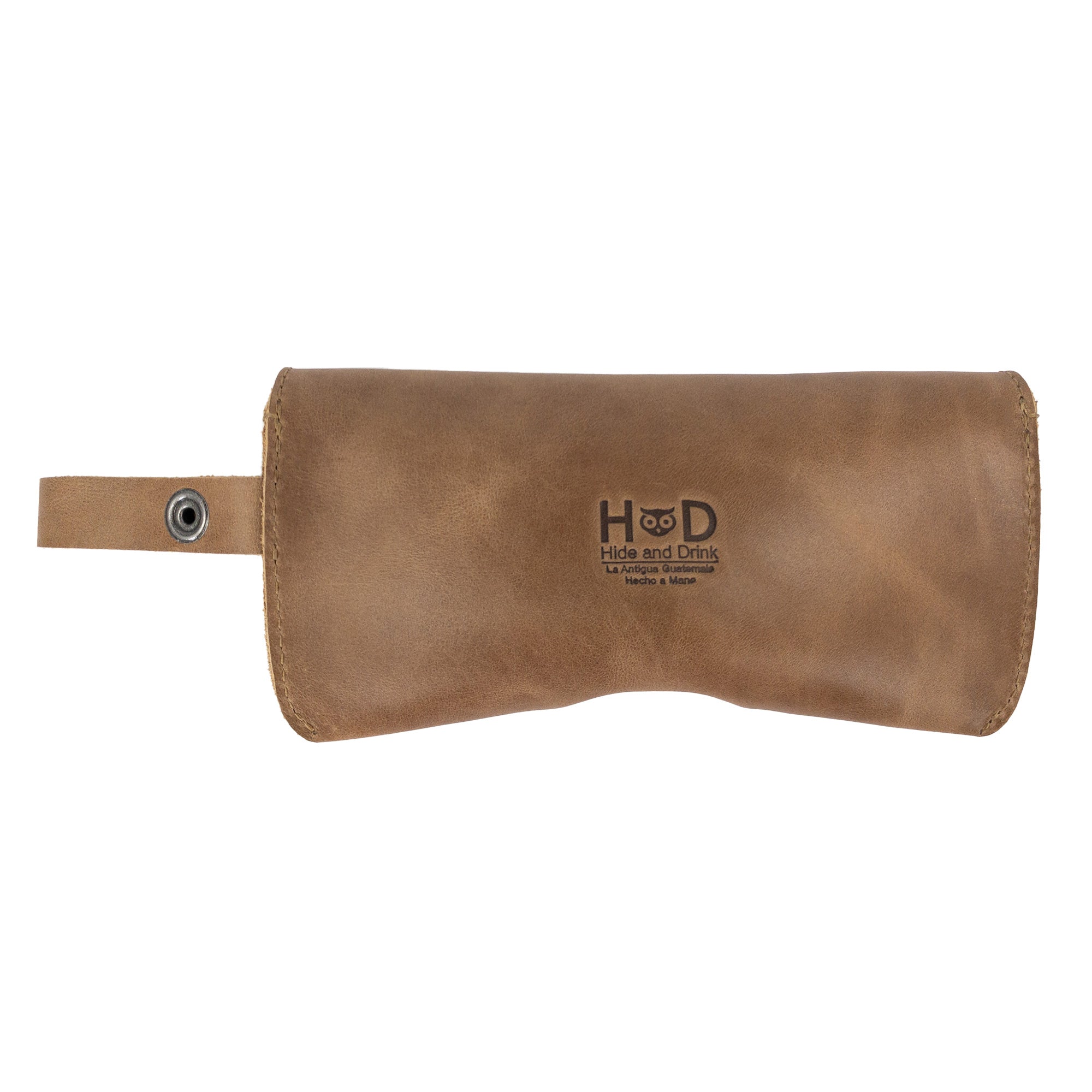 Light Brown Eyeglasses Case with Strap from Hide & Drink, featuring a charming rustic style. This sunglasses case is made from durable full grain leather, serving as a reliable protector for eyewear, showcasing handmade production in La Antigua Guatemala & Oaxaca Mexico.
