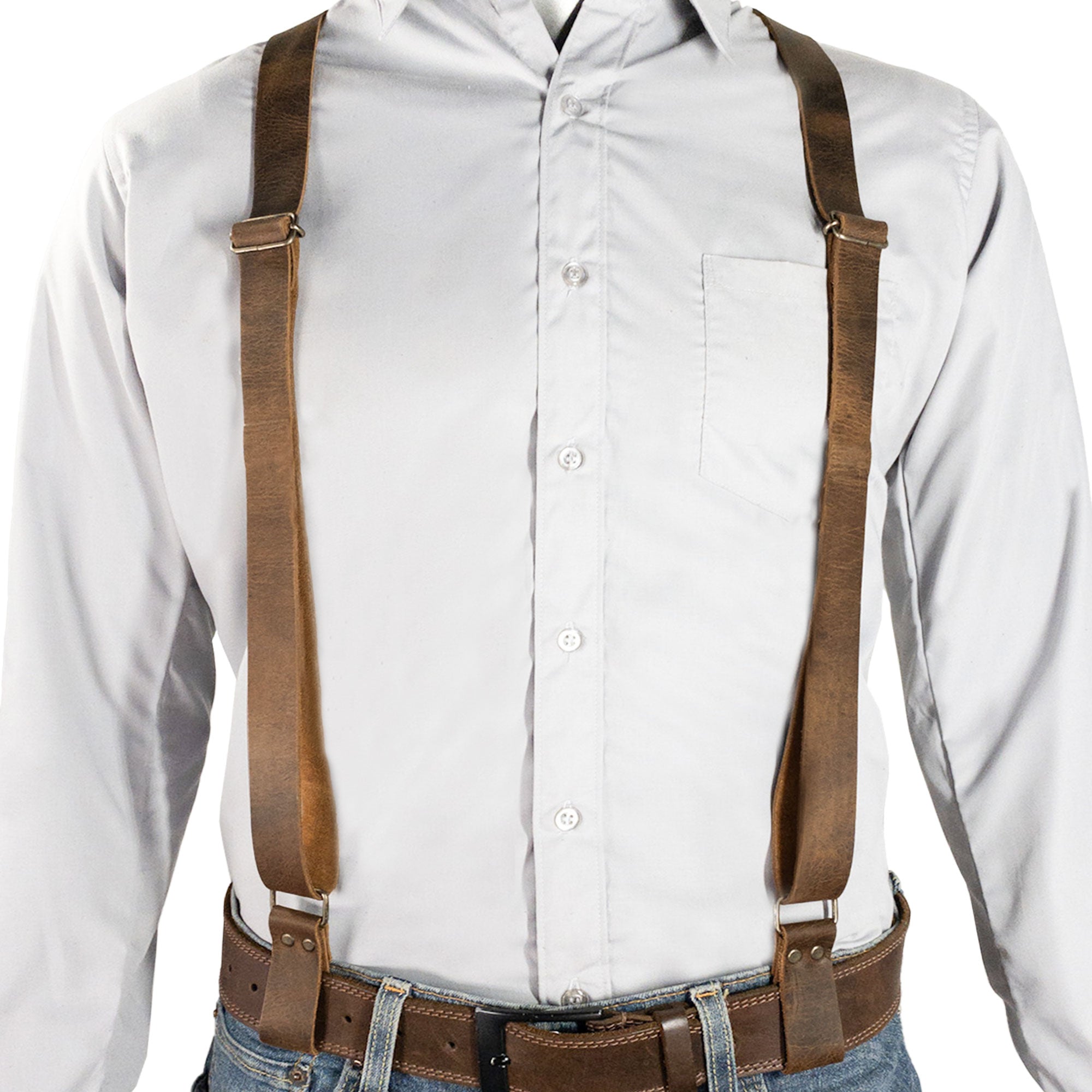 Model wearing Riveted X Back Suspenders with Belt Loops by Hide & Groom, highlighting the adjustable straps and classic style suitable for casual or formal attire. Built from heavy duty harness material and full grain leather, this handmade product is perfect for various occasions.