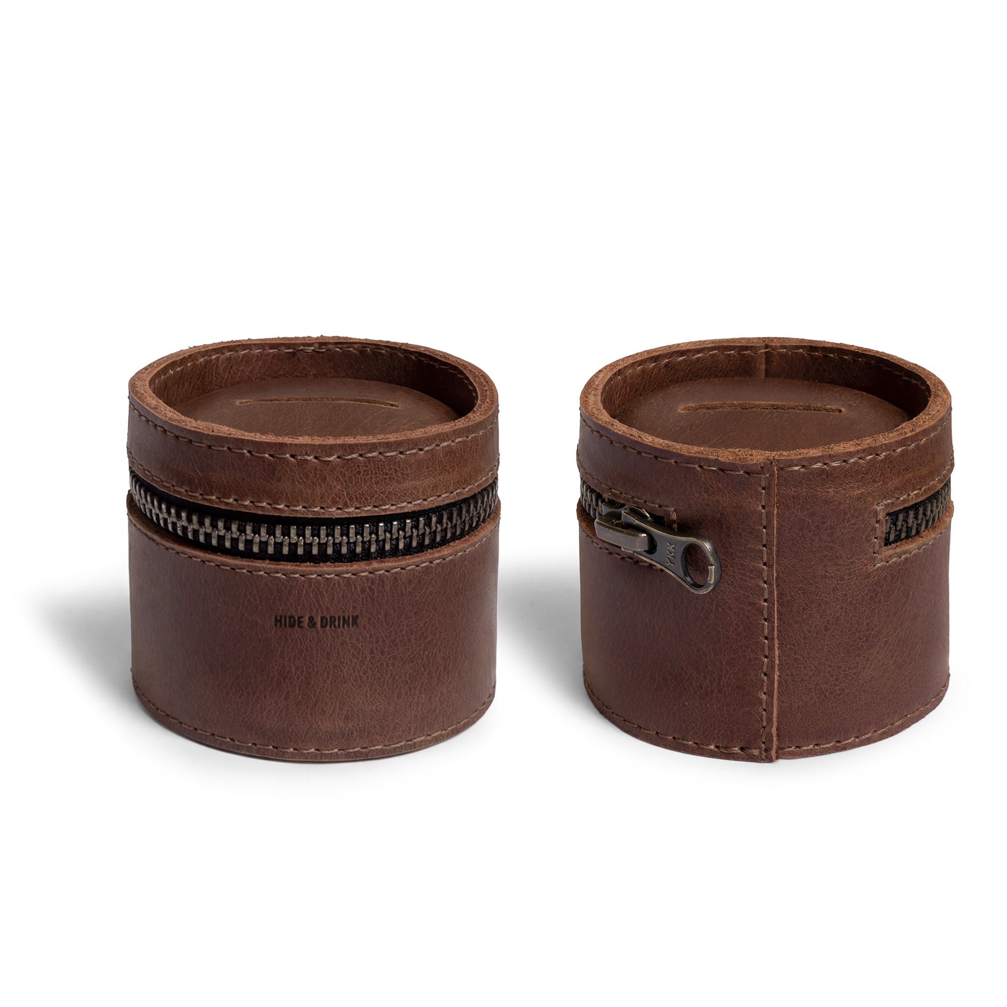 A close-up of the Bucket Coin Release from Hide & Drink, showcasing its sleek design as a money box and piggy bank bucket. This full grain leather zippered pouch serves as a cash organizer and coin case, emphasizing the brand's commitment to small batch production and artisan craftsmanship.