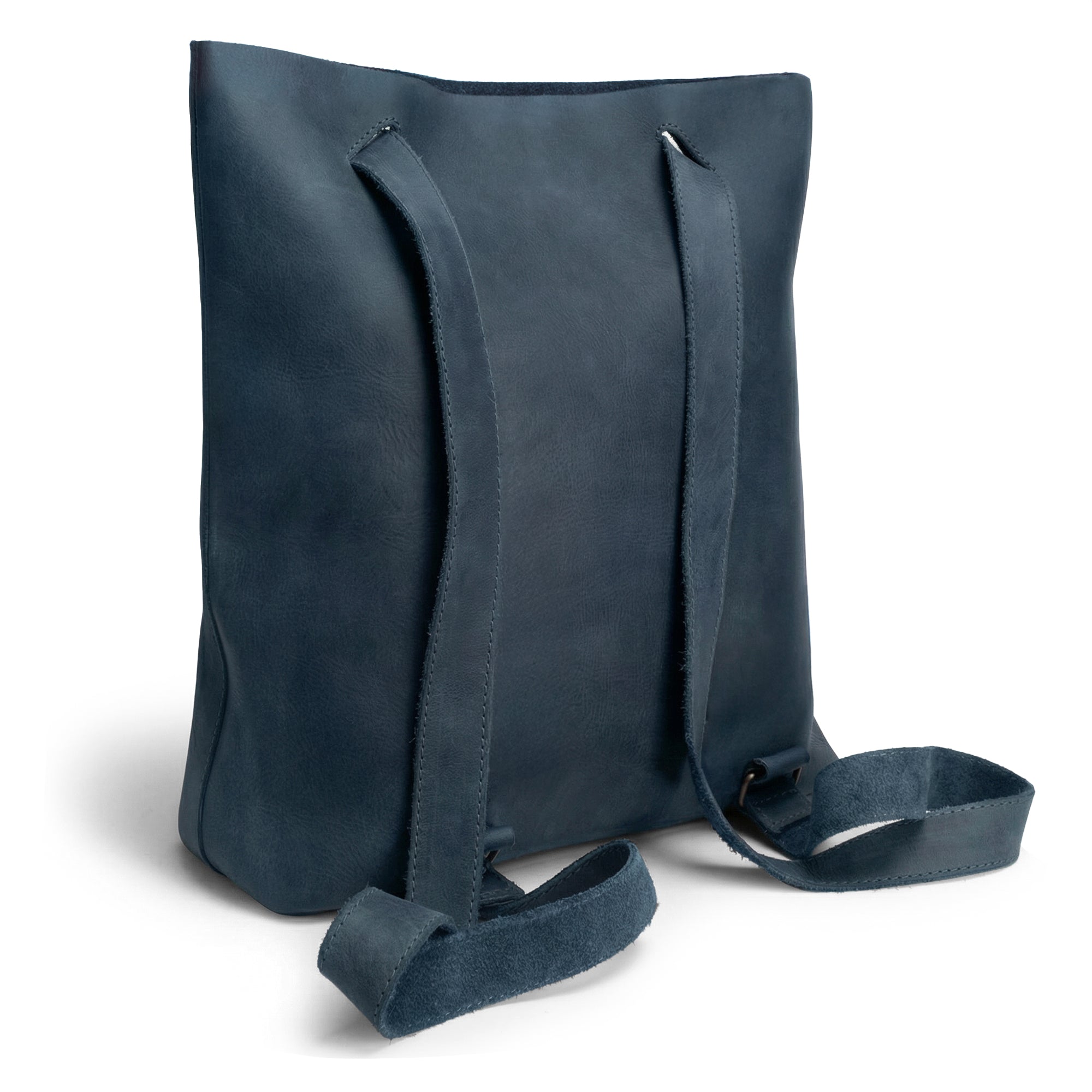 Back view of Heather's Convertible Backpack to Shoulder Bag, highlighting adjustable straps and the quality of Full Grain Leather. This stylish, spacious crossbody for women is a testament to small batch production, hand cut, hand sewn, and fire branded by artisans in La Antigua Guatemala & Oaxaca Mexico.