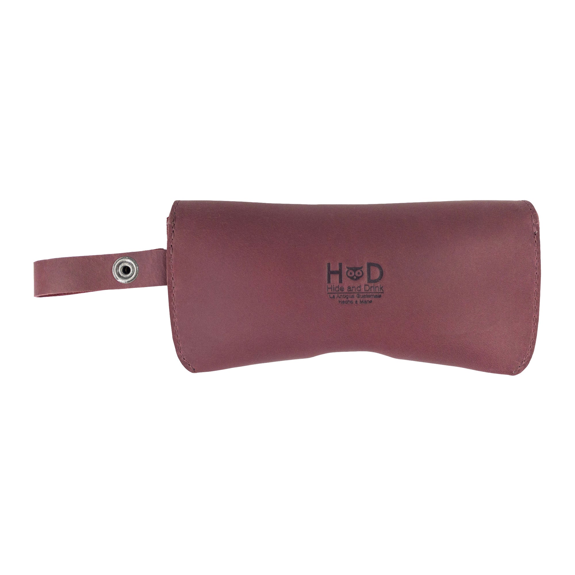Closed Burgundy Eyeglasses Case with Strap from Hide & Drink, showcasing a classic silhouette in full grain leather. This sturdy sunglasses case acts as an effective protector for eyewear, all handmade in La Antigua Guatemala & Oaxaca Mexico.