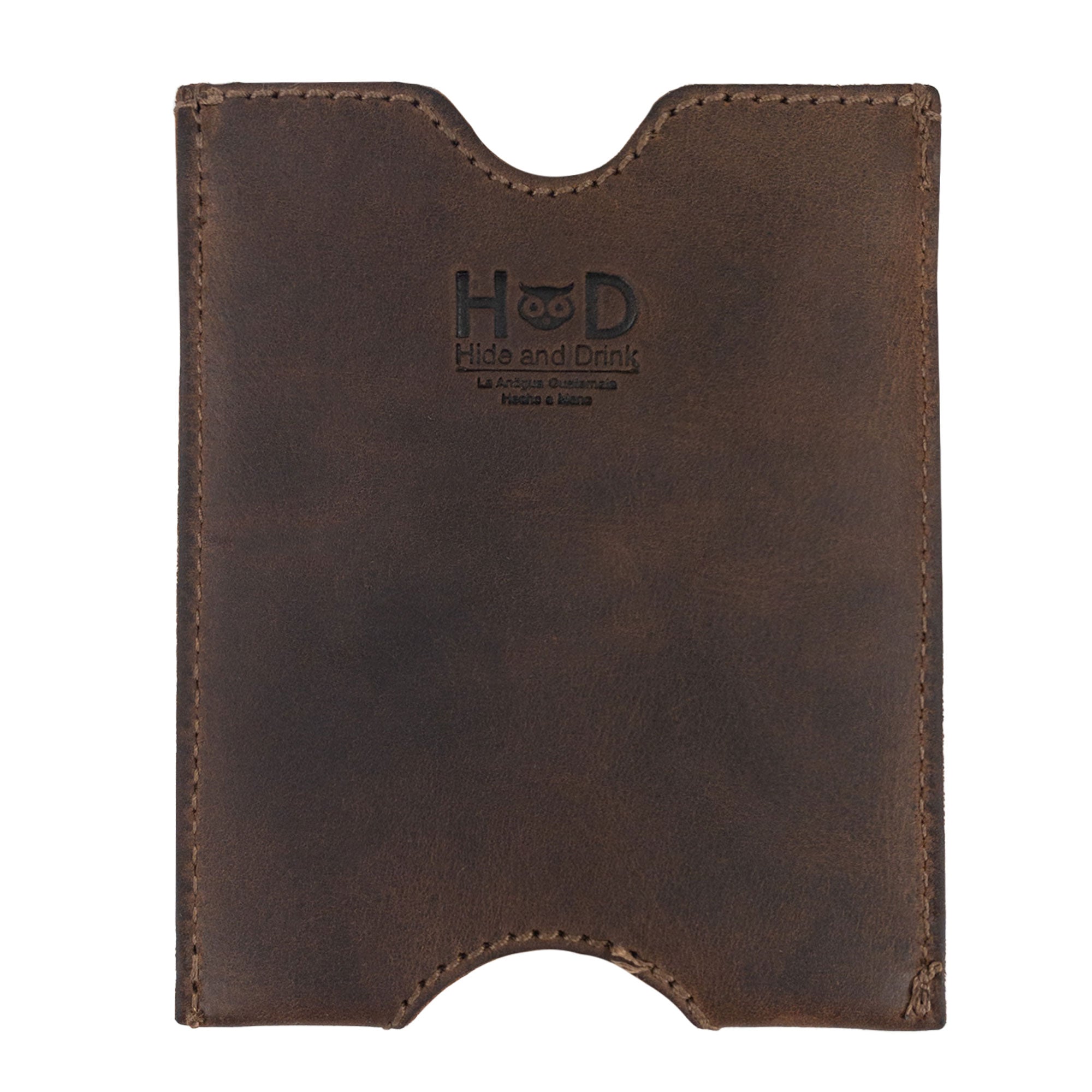 Hide & Drink Passport Sleeve with the logo clearly visible, highlighting its artisanal craftsmanship. This Travel Passport Pocket Sleeve, made of Full Grain Leather, is hand sewn and fire branded, perfect for discerning travelers.