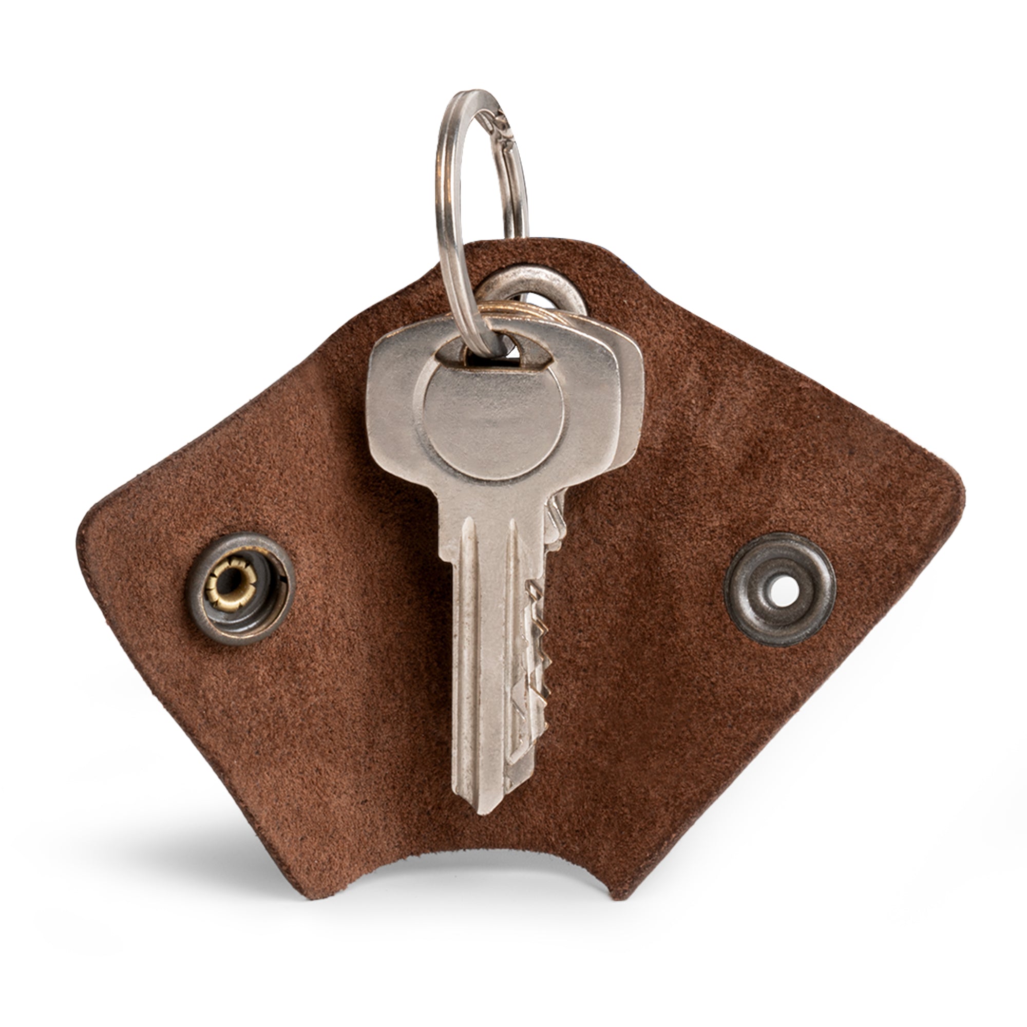 Functional Wrap Keychain from Hide & Drink, designed with a secure organizer snap closure for effective key management. This key ring cover acts as a silencer sleeve key holder for men, made from high-quality full grain leather. Each piece is artisan crafted in La Antigua Guatemala, emphasizing small batch production and meticulous hand cut and hand sewn details.