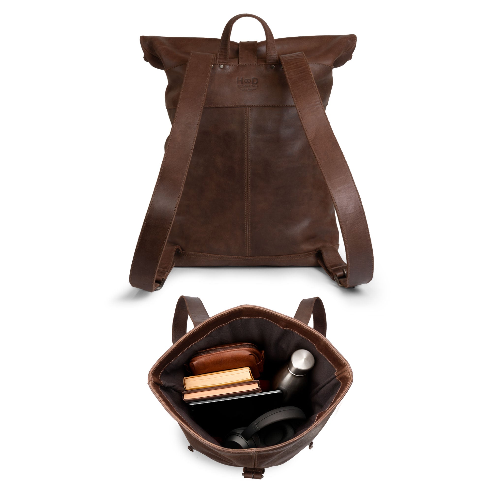 Interior view of the Roll Top Backpack by Hide & Drink, featuring a spacious design suitable for laptops and a beautiful plaid cotton lining, highlighting its functionality as a travel accessory crafted from high-quality leather.