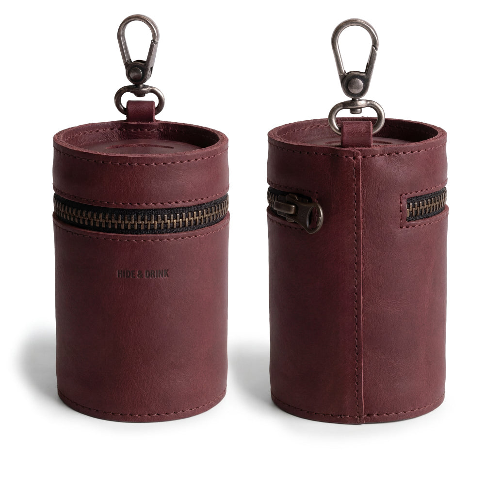 Featuring the Bucket Coin Release from Hide & Drink, this image highlights the elegant design of a zipper pouch piggy bank bucket that is perfect for organizing loose change. Made with durable full grain leather and crafted with meticulous attention to detail, it embodies small batch production.