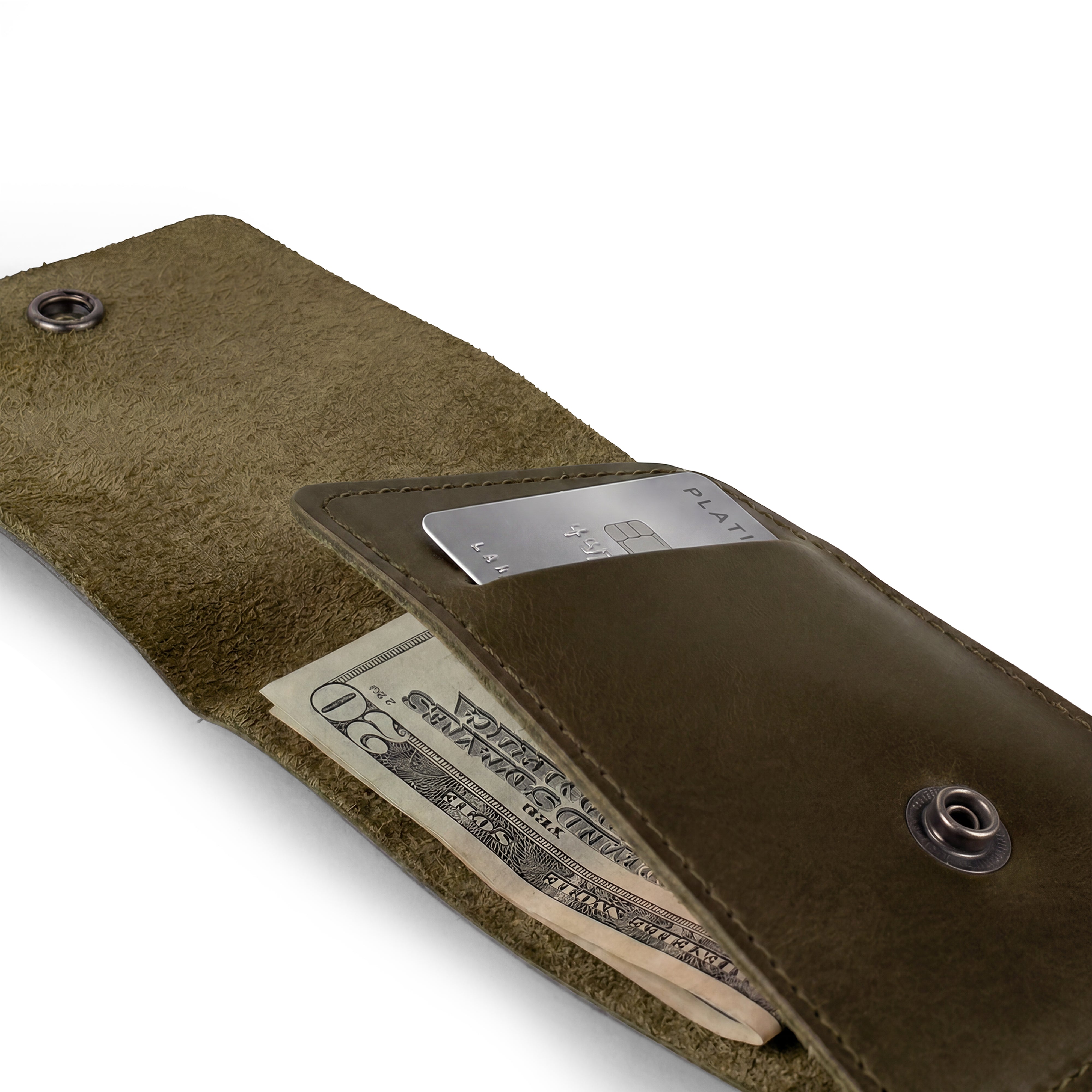 Side view of the green Vertical Wallet by Hide & Drink showcasing its compact profile. This Vertical Front Pocket Wallet with Card Slot provides stylish storage for bills and cards, crafted of full grain leather through small batch processes with hand cut and hand sewn artistry, fire branded for a unique touch. Handmade in La Antigua Guatemala & Oaxaca Mexico.