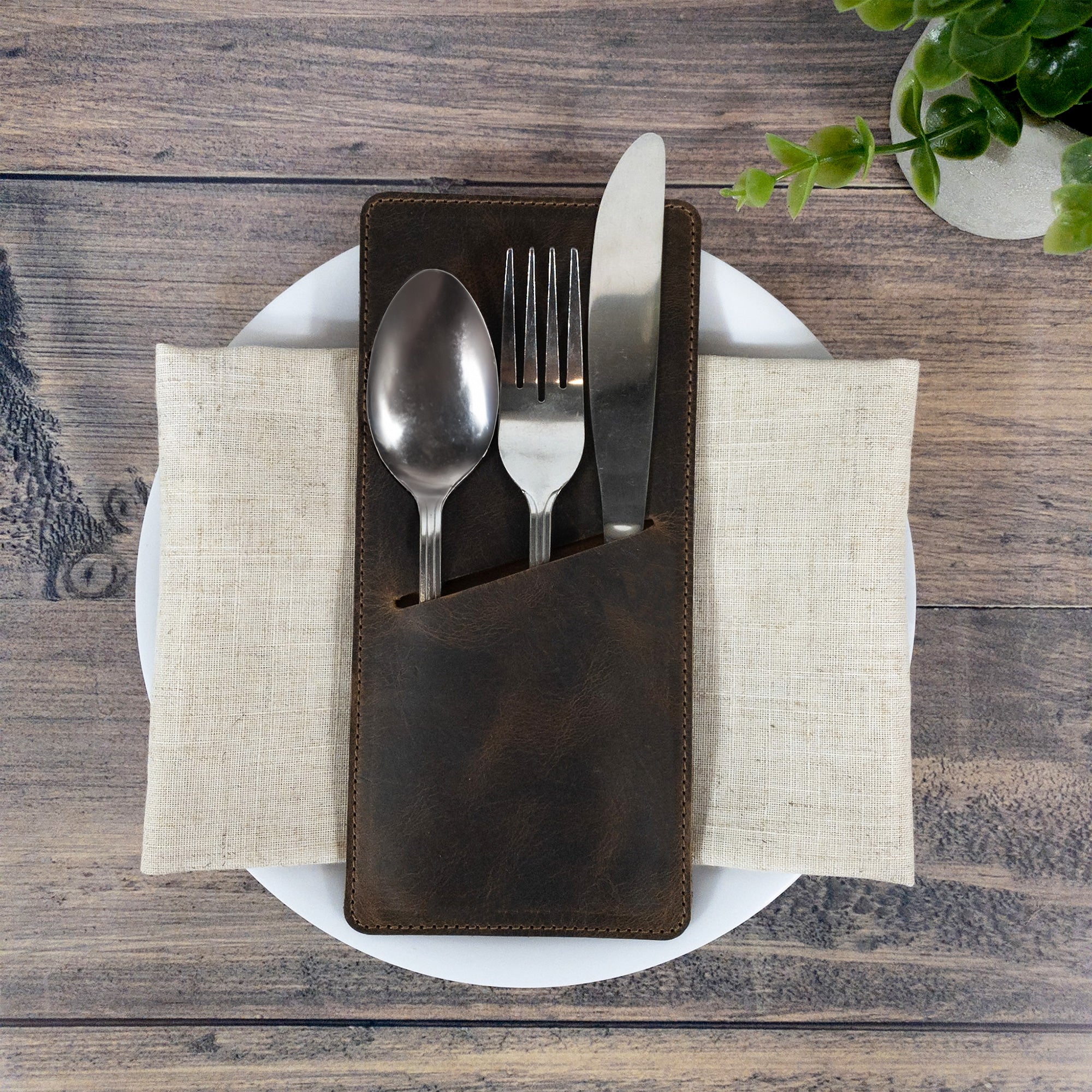 Stylish presentation of the Set of 2 Rectangular Sleeves for Cutlery by Cast Leather Co., holding utensils securely for a beautiful place setting. Made from full grain leather, these artisan pieces emphasize handmade quality, small batch production, and exquisite craftsmanship in La Antigua Guatemala & Oaxaca Mexico.