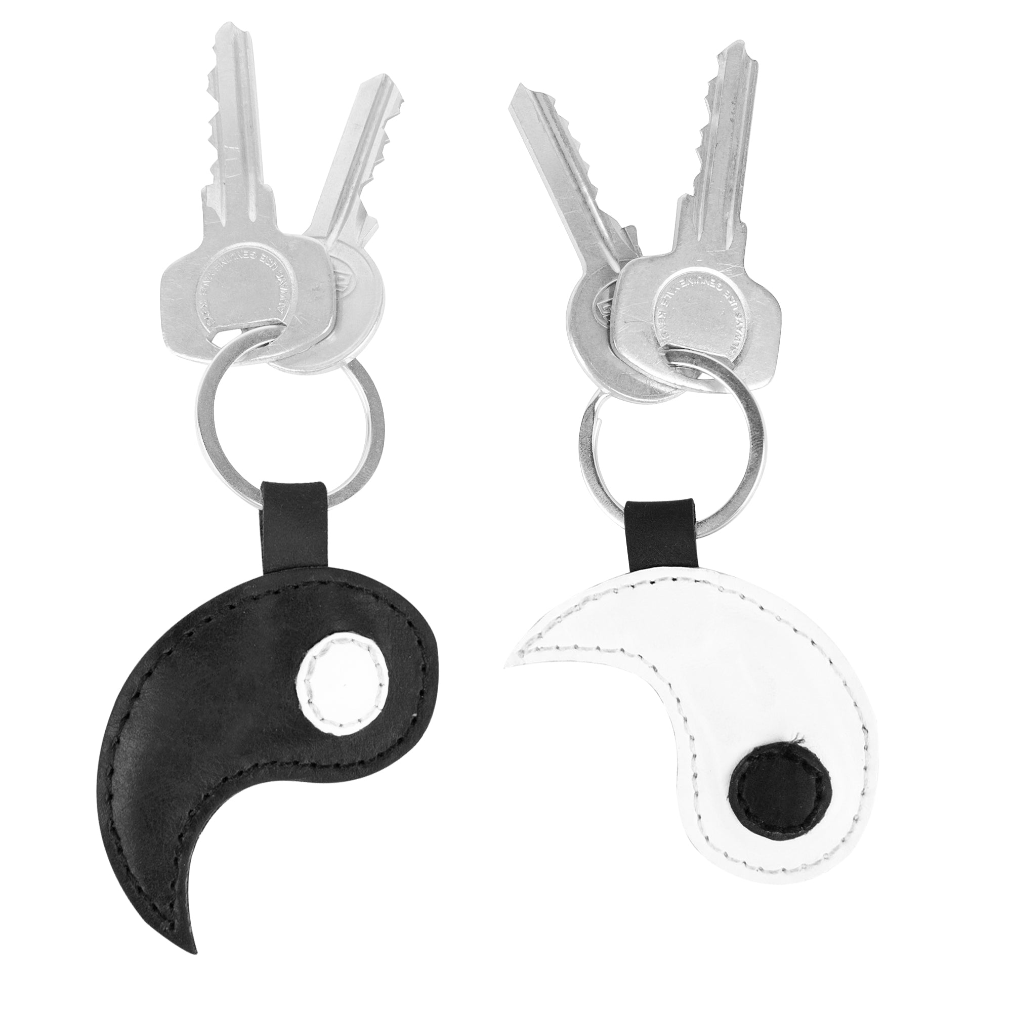 Dual Yin Yang Keychains (2 pieces) by Hide & Drink showcased with two elegant key rings, embodying the essence of inseparable connections. These full grain leather accessories reflect Chinese culture and make excellent friendship gifts, crafted through small batch production methods. Each keychain is hand cut, hand sewn, and fire branded, showcasing a commitment to artisan quality, created in La Antigua Guatemala & Oaxaca Mexico.