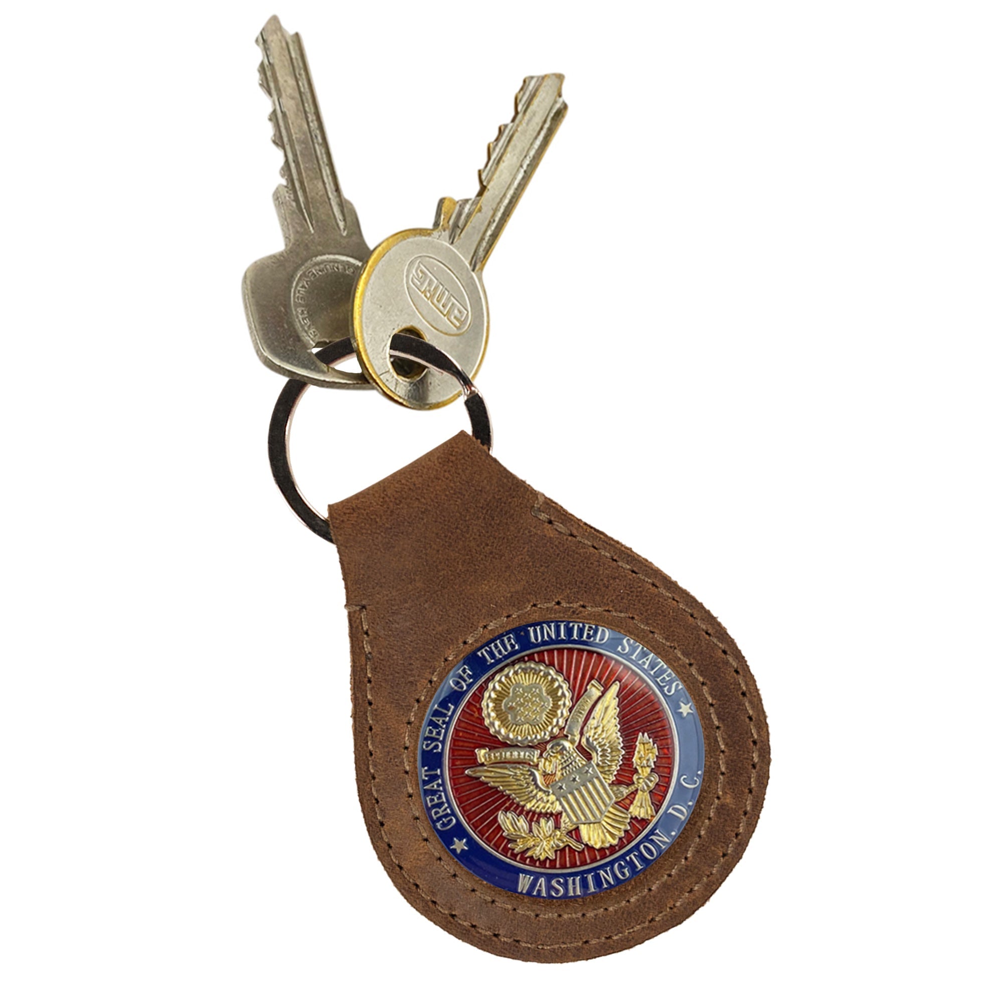 The Medallion Holder Keychain by Hide & Drink adorned with keys, illustrating its secure keyring attachment perfect for collectors and keepsake lovers. Crafted from fine full grain leather, this handmade item embodies artisan quality from La Antigua Guatemala & Oaxaca Mexico.