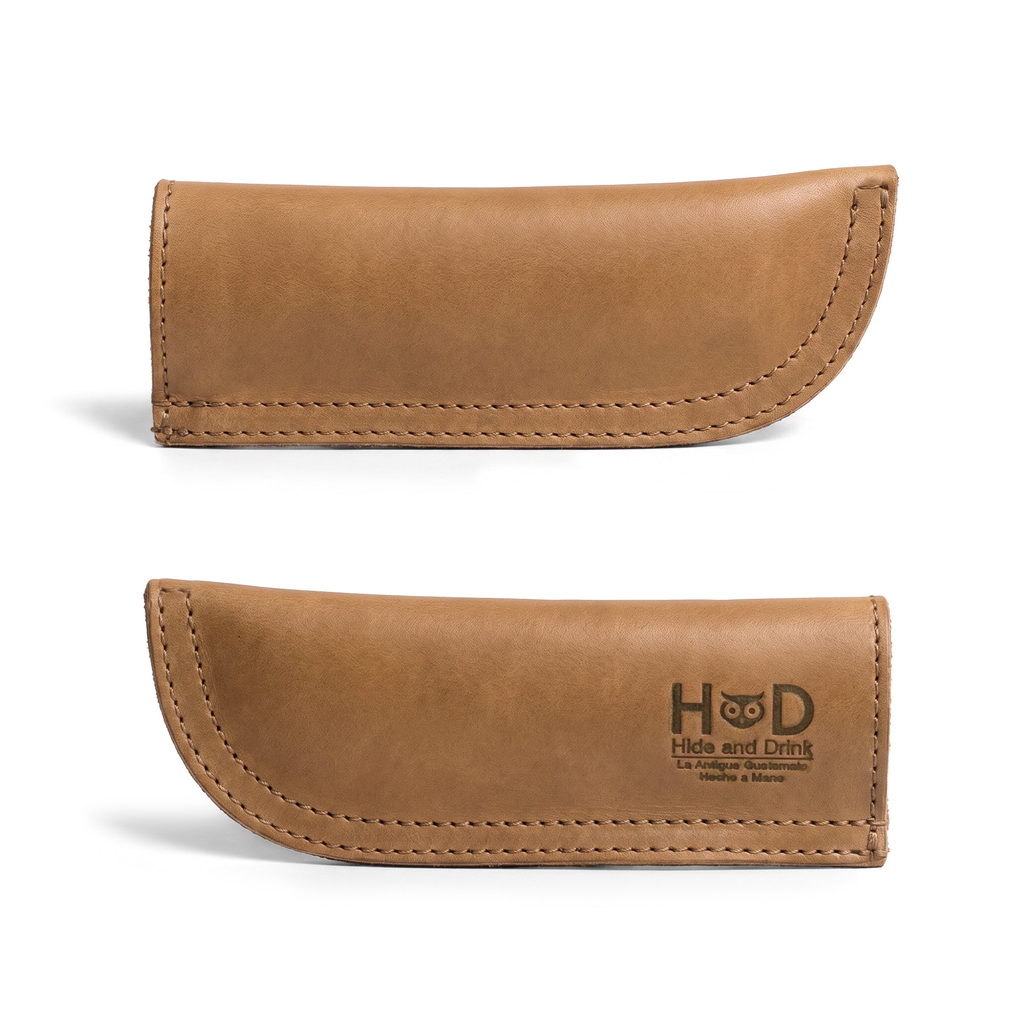 Hide & Drink Cast Iron Panhandle Cover showcasing its unique design on a skillet. This handcrafted hot handle protector, made from full grain leather, is double stitched for durability and easy to grip. Artisan-crafted in La Antigua Guatemala & Oaxaca Mexico, it's perfect for enhancing your cooking experience.