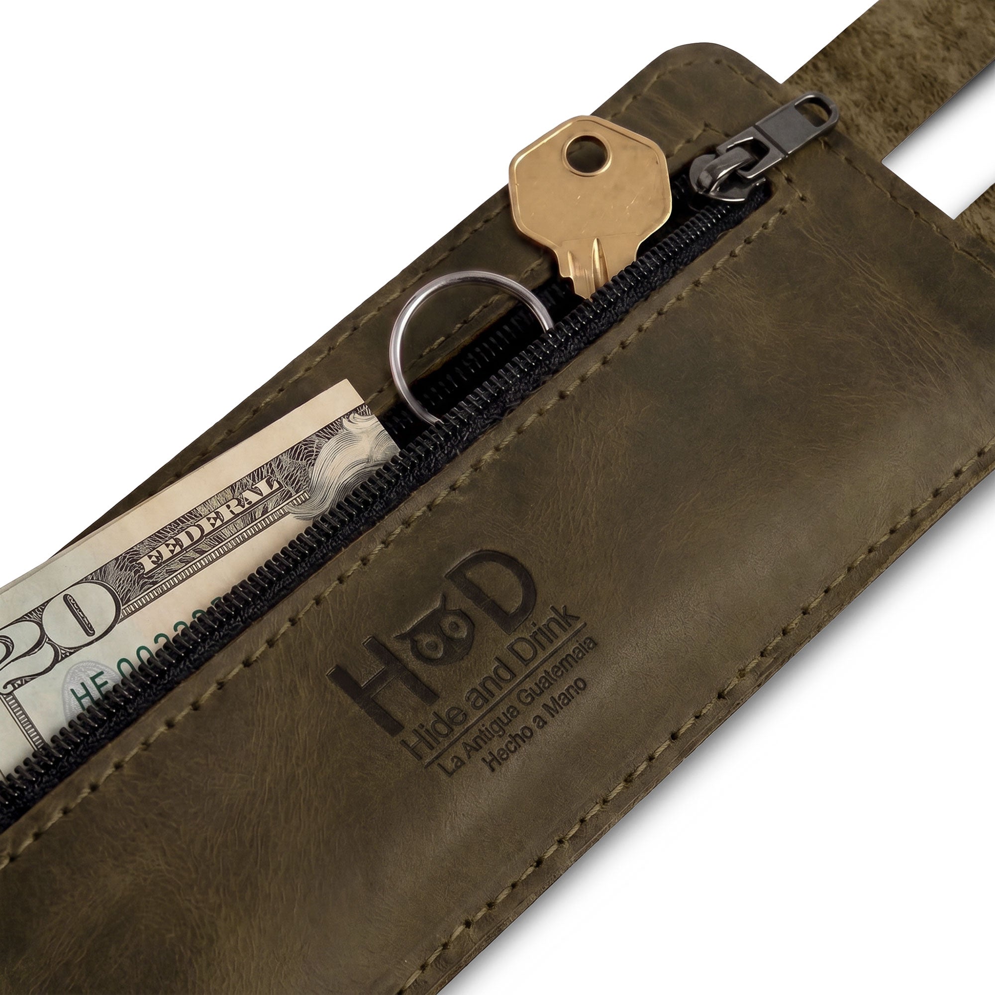 The unique design of Hide & Drink's Wrist-Wallet-Cuff stands out in Full Grain Leather. This rustic leather bracelet offers a hidden pouch for bills and an inner zippered pouch, blending style and practicality effortlessly. Handcrafted in La Antigua Guatemala & Oaxaca Mexico, celebrating the tradition of artisan craftsmanship.