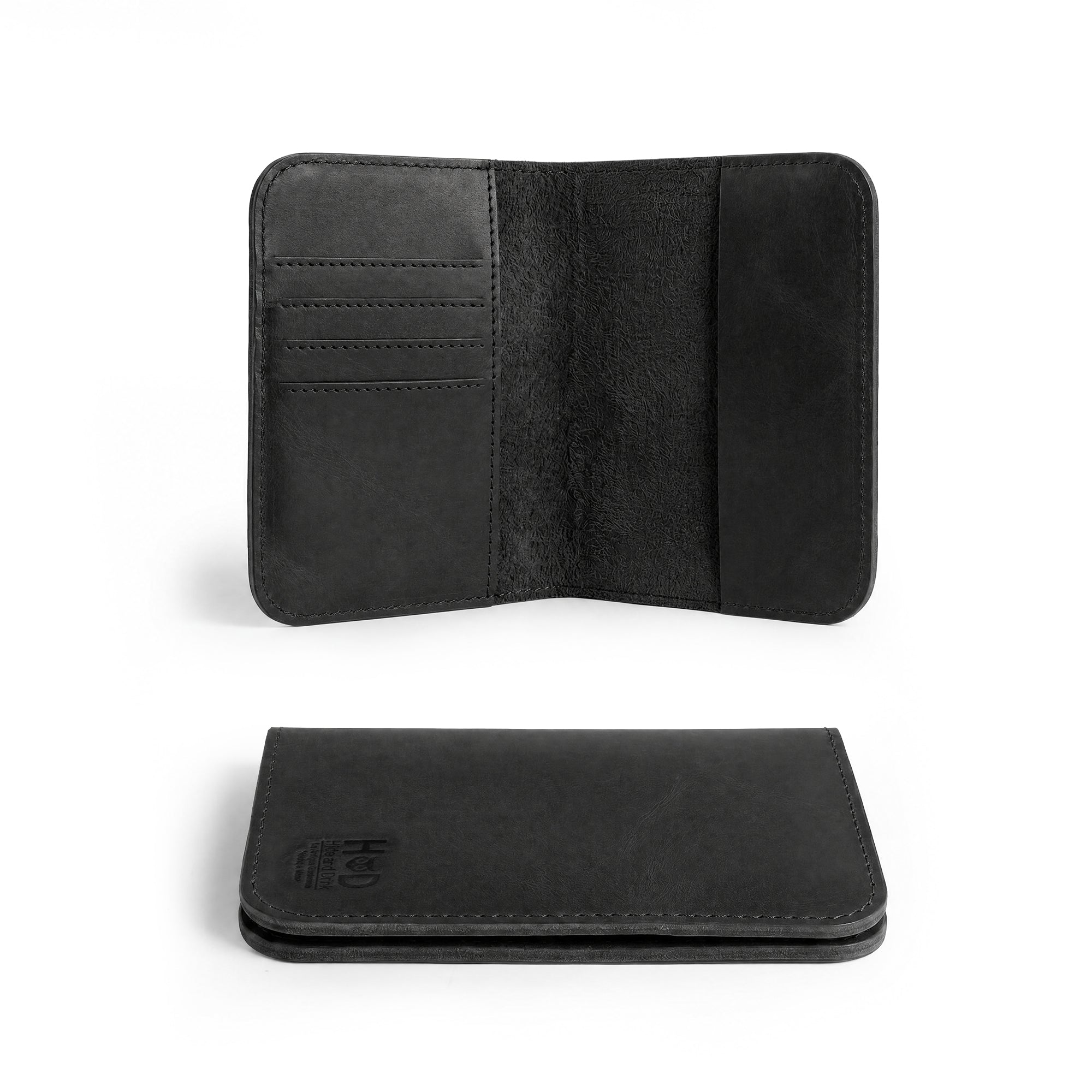 Detailed in-the-hand view of the Hide & Drink Travel Wallet, demonstrating its compact design. This travel wallet serves as a bifold passport case, expertly made from full grain leather in La Antigua Guatemala.