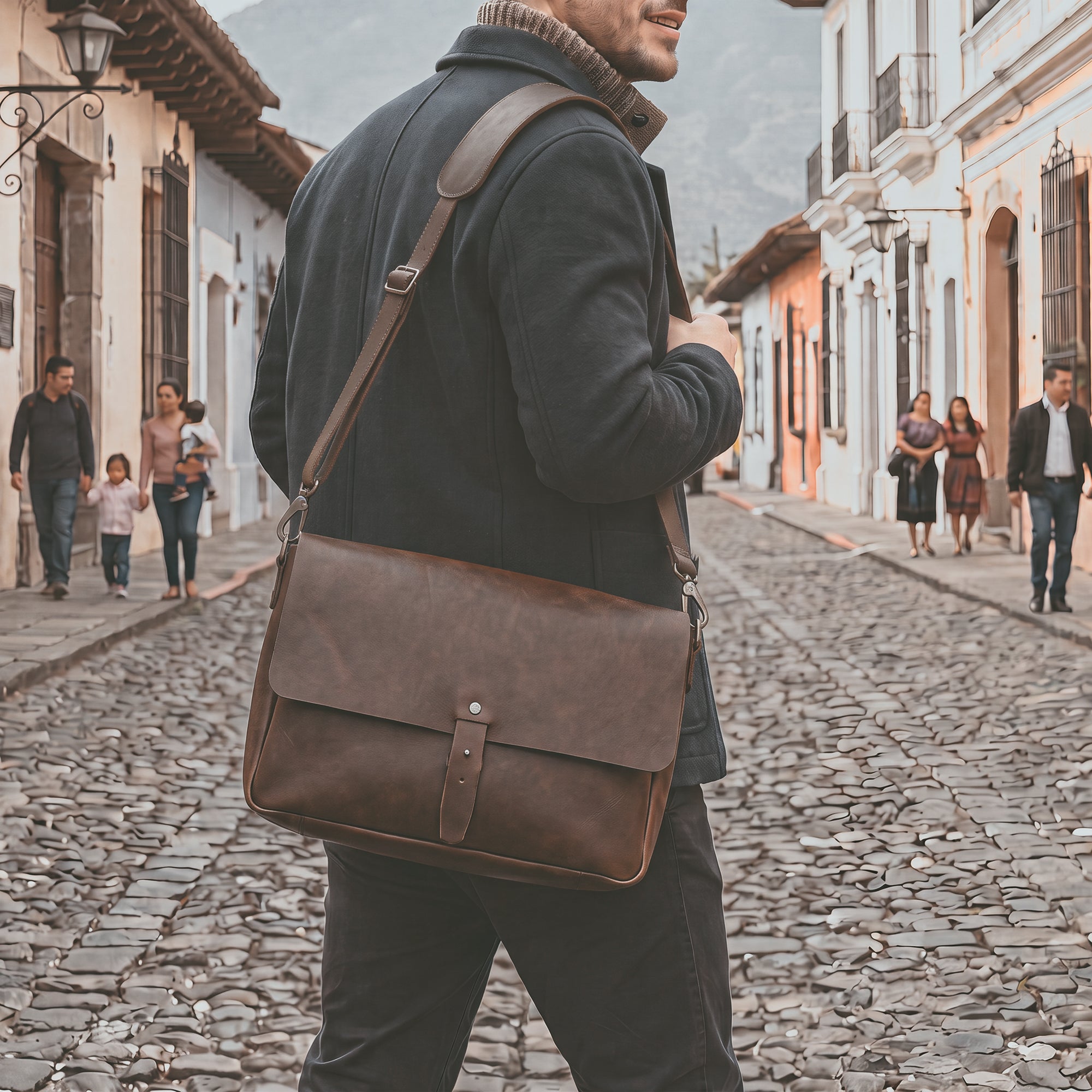 Side view of Hide & Drink's Messenger Bag with Adjustable Strap, emphasizing its stylish design and full grain leather finish. Perfect as a classic portfolio or a travel accessory, this messenger bag features small batch production with hand cut and hand sewn artistry. Handmade in La Antigua Guatemala & Oaxaca Mexico.
