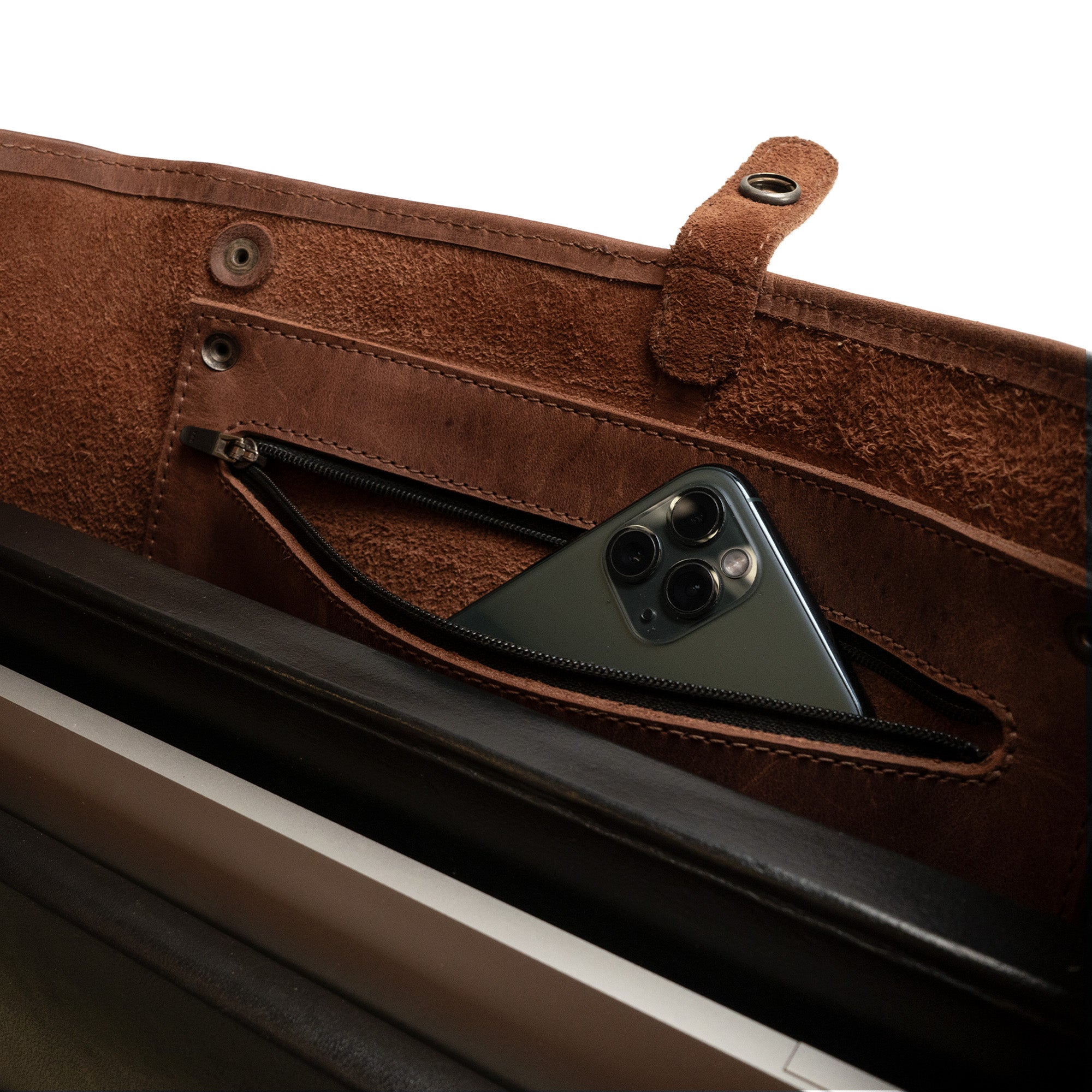 Close-up of the interior of a Formal Tote Bag by Hide & Drink, featuring a convenient pocket pouch with zipper for added security. This classy handbag is designed for women on the go, combining functionality with style for both business and casual settings. The soft leather design makes it an essential accessory for any outfit.