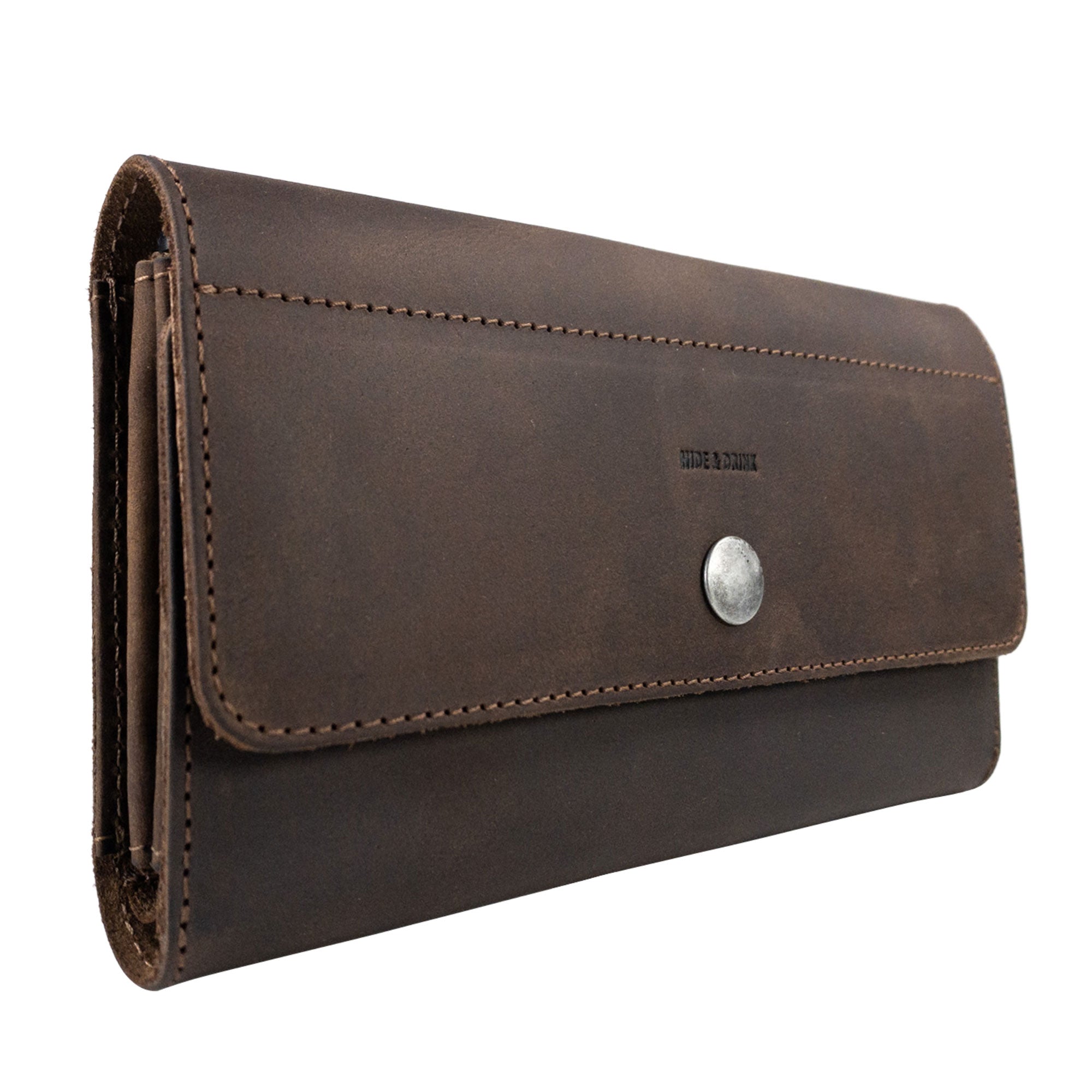 Side profile of the Rustic Tri Fold Folio Wallet by Hide & Drink, illustrating its compact design and durable full grain leather. This wallet serves as a Minimalist Tri Fold Folio Wallet for Women, featuring artisan quality through small batch production, hand cut, and hand sewn techniques, made with care in La Antigua Guatemala & Oaxaca Mexico.