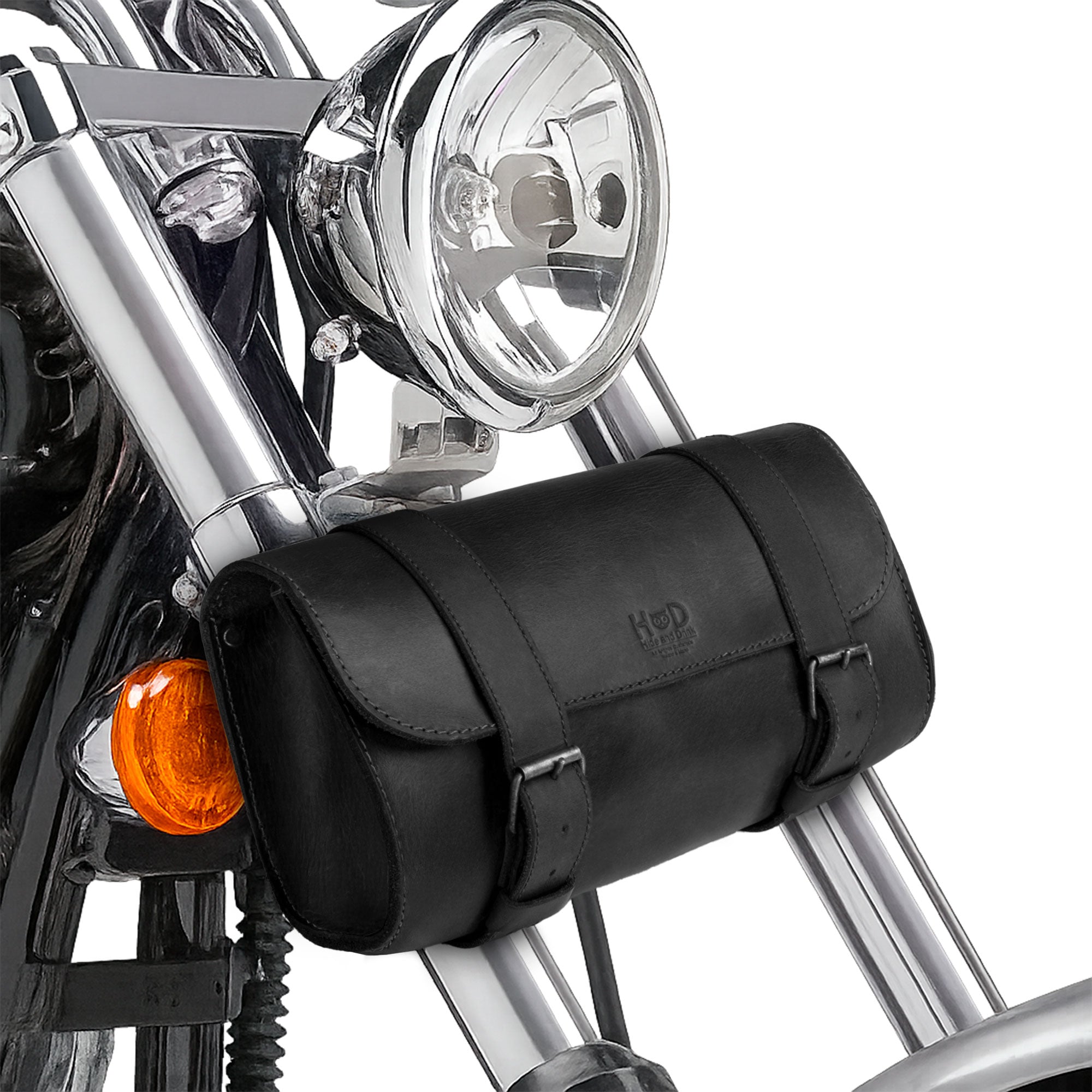 Hide & Drink Leather Motorcycle Tool Bag positioned stylishly, made of premium Full Grain Leather, ideal for motorcycle lovers seeking a versatile Biker Bag for Tools and Essentials. This Handlebar Bag with Adjustable Straps also acts as a practical Tool Organizer, handcrafted in La Antigua Guatemala & Oaxaca Mexico.
