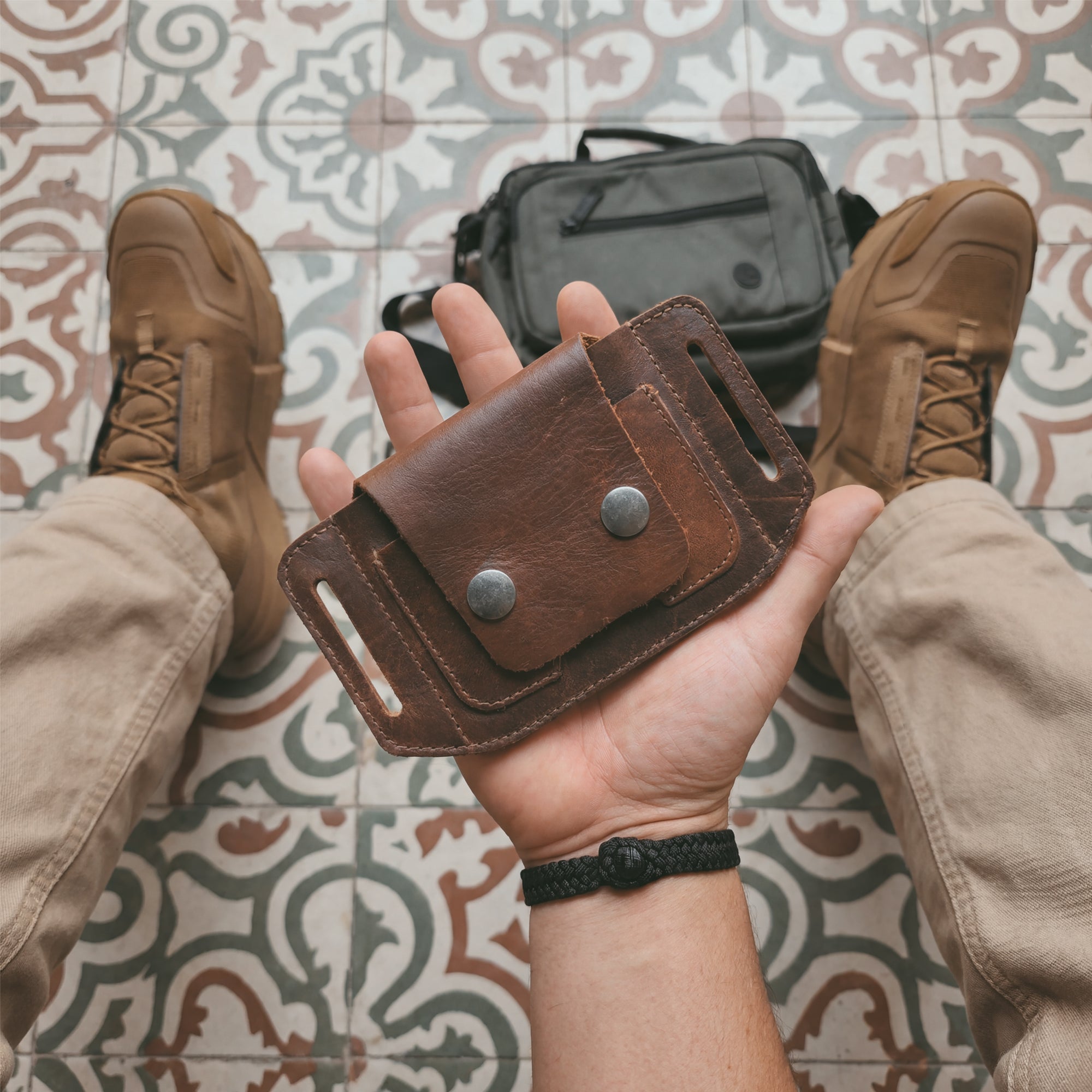 Side view of the Hide & Drink Tactical Card Holder displaying its practical pocket design and button snap closures. This full grain leather card holder is perfect for convenient card storage while on-the-go. Crafted through small batch production, it features hand cut and hand sewn details along with fire branding. Artisan craftsmanship from La Antigua Guatemala & Oaxaca Mexico.