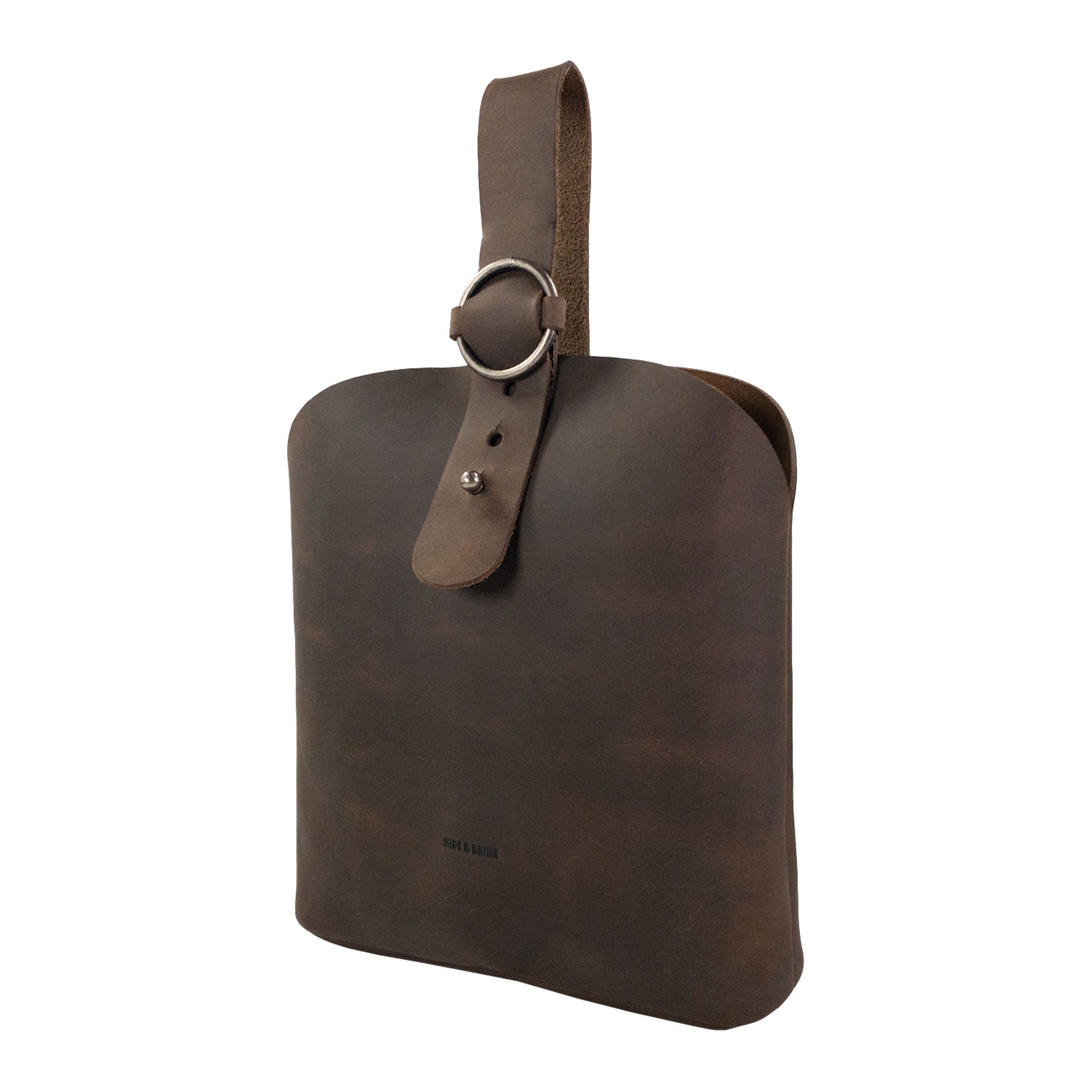 Showcasing the side view of the Rounded Handbag by Hide & Drink, highlighting its elegant shape and sturdy strap, ideal for any traveler. This artisan-crafted bag made from full grain leather emphasizes hand cut, hand sewn quality, reflecting small batch production and fire branded artistry, handmade in La Antigua Guatemala & Oaxaca Mexico.