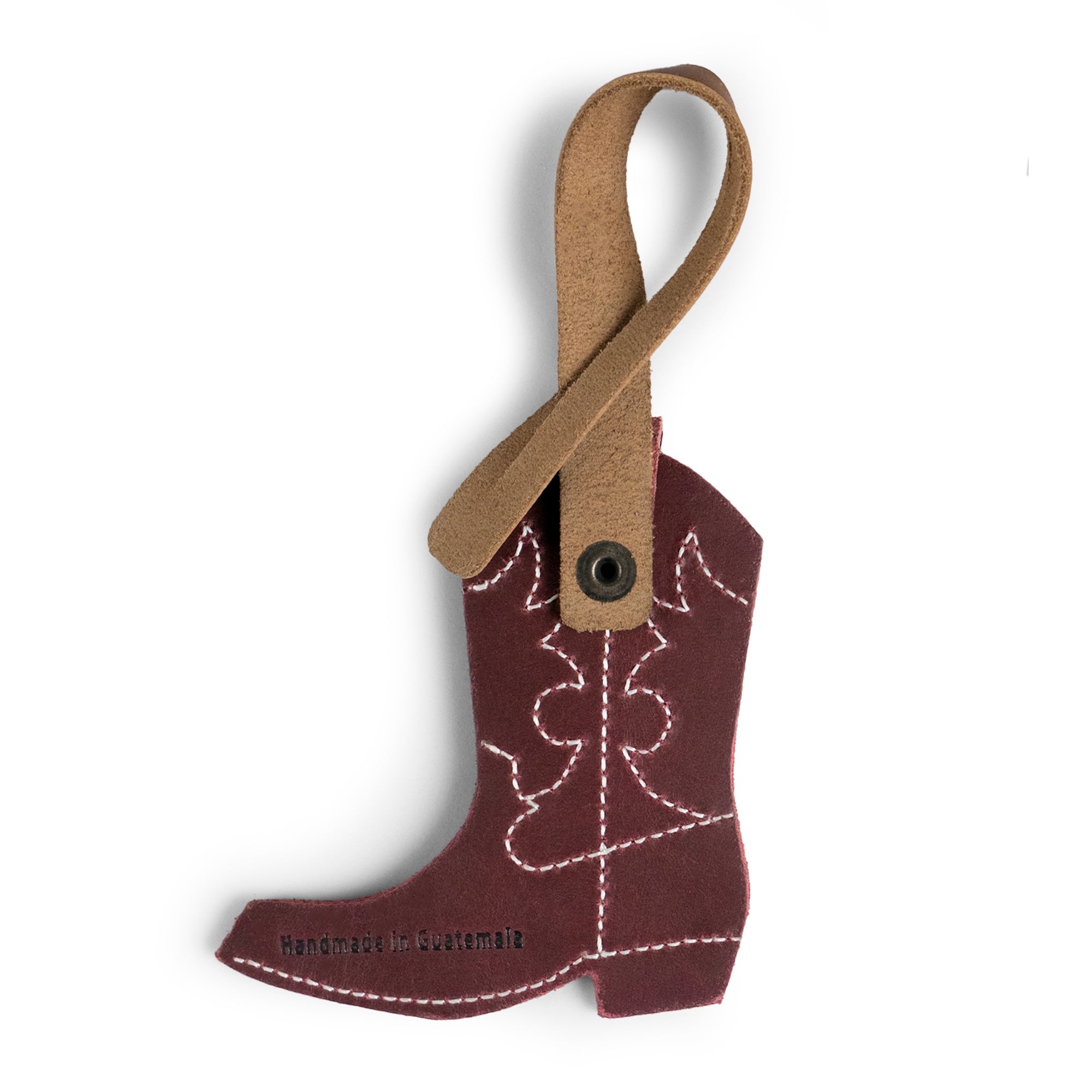 This Western Boot Bag Charm by Hide & Drink features a vibrant leather cowboy boot design, a perfect addition to enhance your handbags or backpacks. Crafted from full grain leather in La Antigua, Guatemala & Oaxaca, Mexico, it highlights small batch production, artisan craftsmanship, and unique fire branded details, making it an elegant ornament for women.