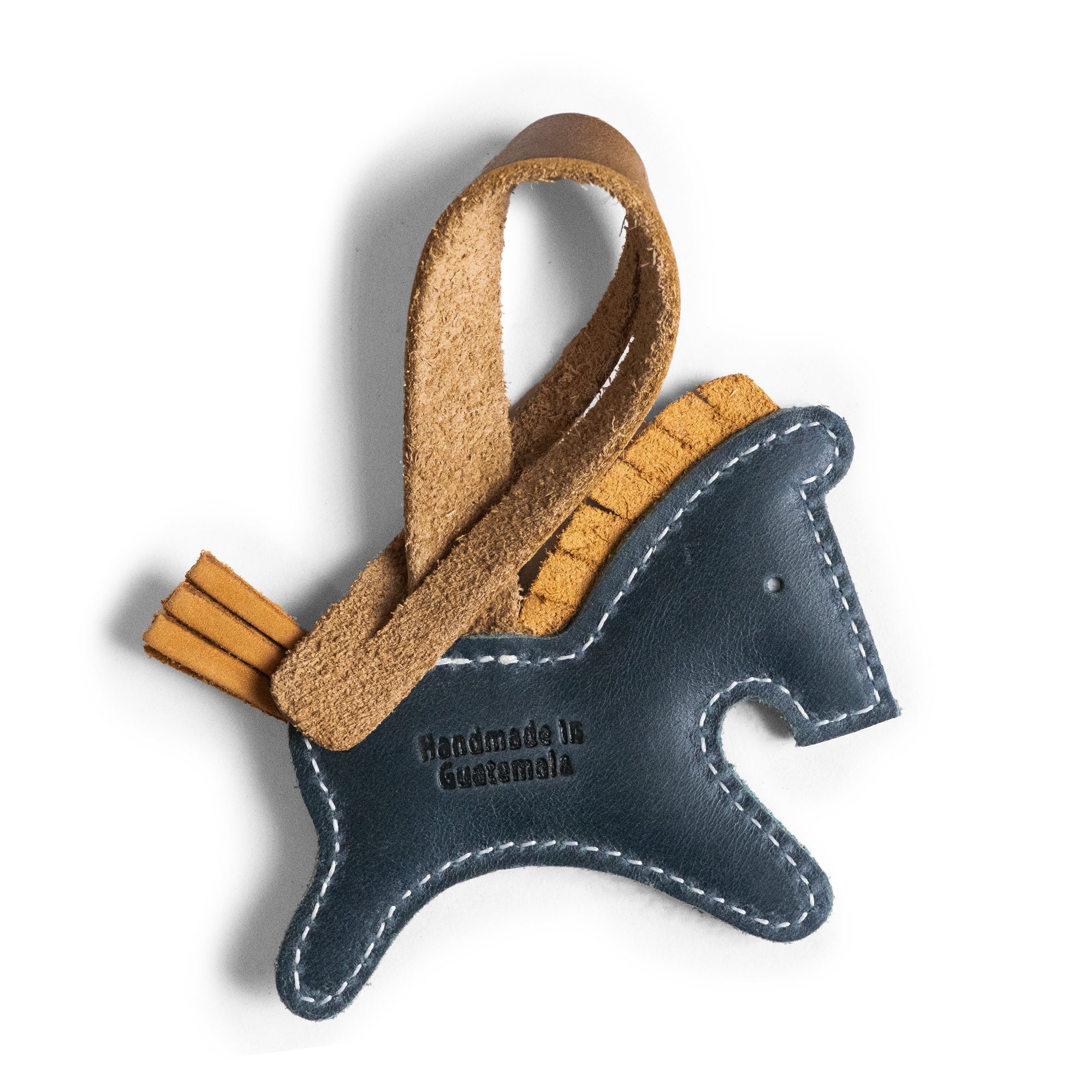 Close-up of the Hide & Drink Horse Bag Charm, highlighting its handmade details and full grain leather. This unique purse charm is perfect for adding flair to handbags or backpacks. Each piece is fire branded and hand sewn, reflecting the artisan skill from La Antigua Guatemala and Oaxaca, Mexico.