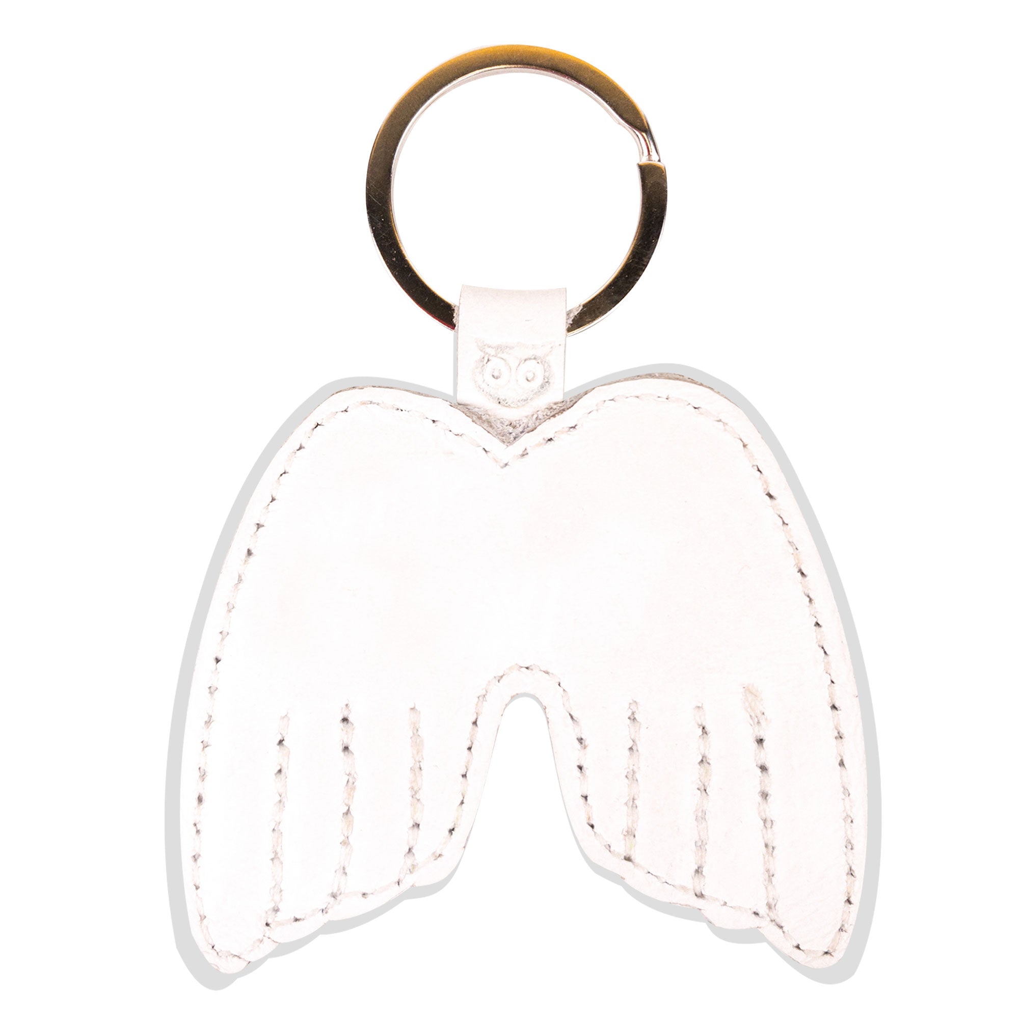 Close-up of the Angel Wings Keychain by Hide & Drink, showcasing its Full Grain Leather texture and unique wing design. This key holder is an artisan-crafted accessory that conveys peace, made with small batch production methods. Handmade in La Antigua Guatemala & Oaxaca Mexico, it features meticulous hand cutting and sewing, along with a fire branded detail.