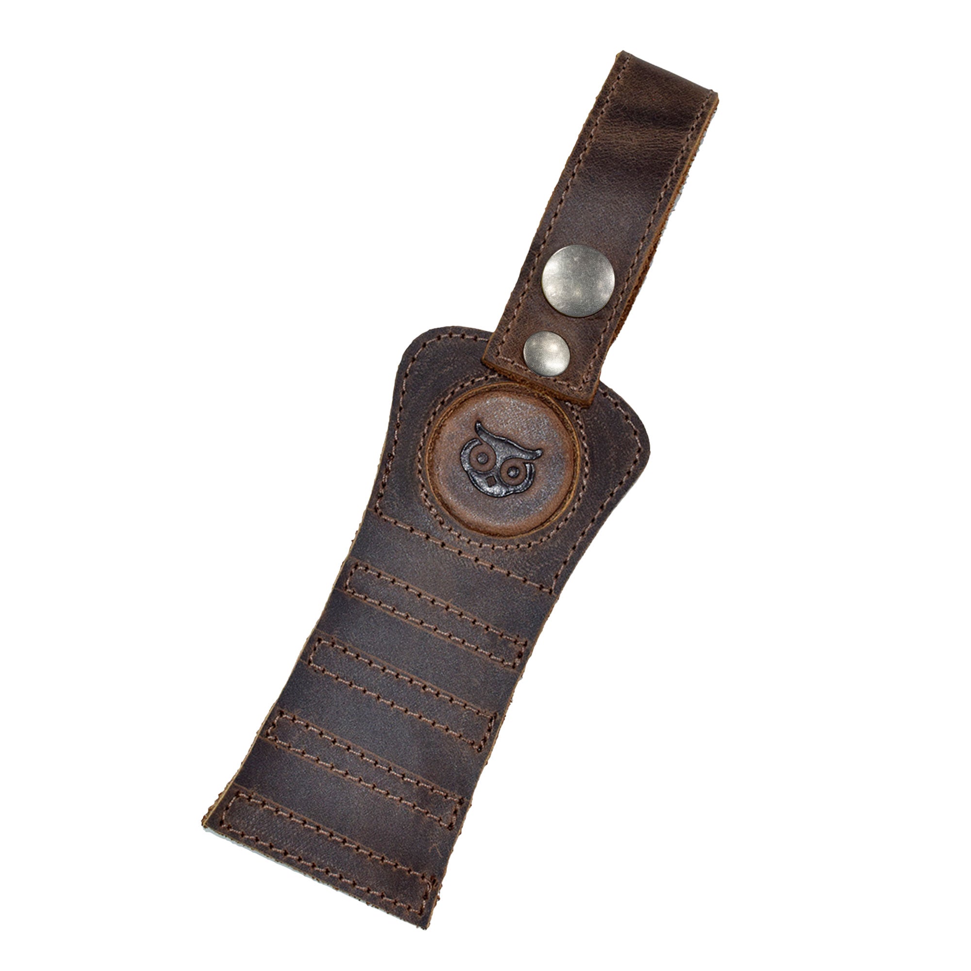 Hide & Drink Golf Tee Holder with a close-up of the signature owl logo in full grain leather. This stylish holder is perfect for golf enthusiasts, offering a convenient way to carry tees with a durable hook for belt or bag attachment, ethically made in La Antigua Guatemala.