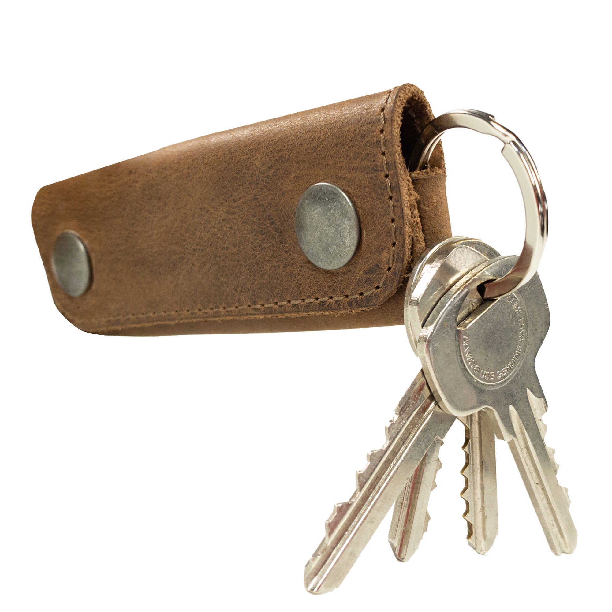 The Double Snap Key Holder from Hide & Drink shows off a stylish design with keys attached, crafted from Full Grain Leather for durability. This artisan accessory serves as a practical Key Ring Organizer while highlighting the commitment to small batch production and handmade quality from La Antigua Guatemala & Oaxaca Mexico.