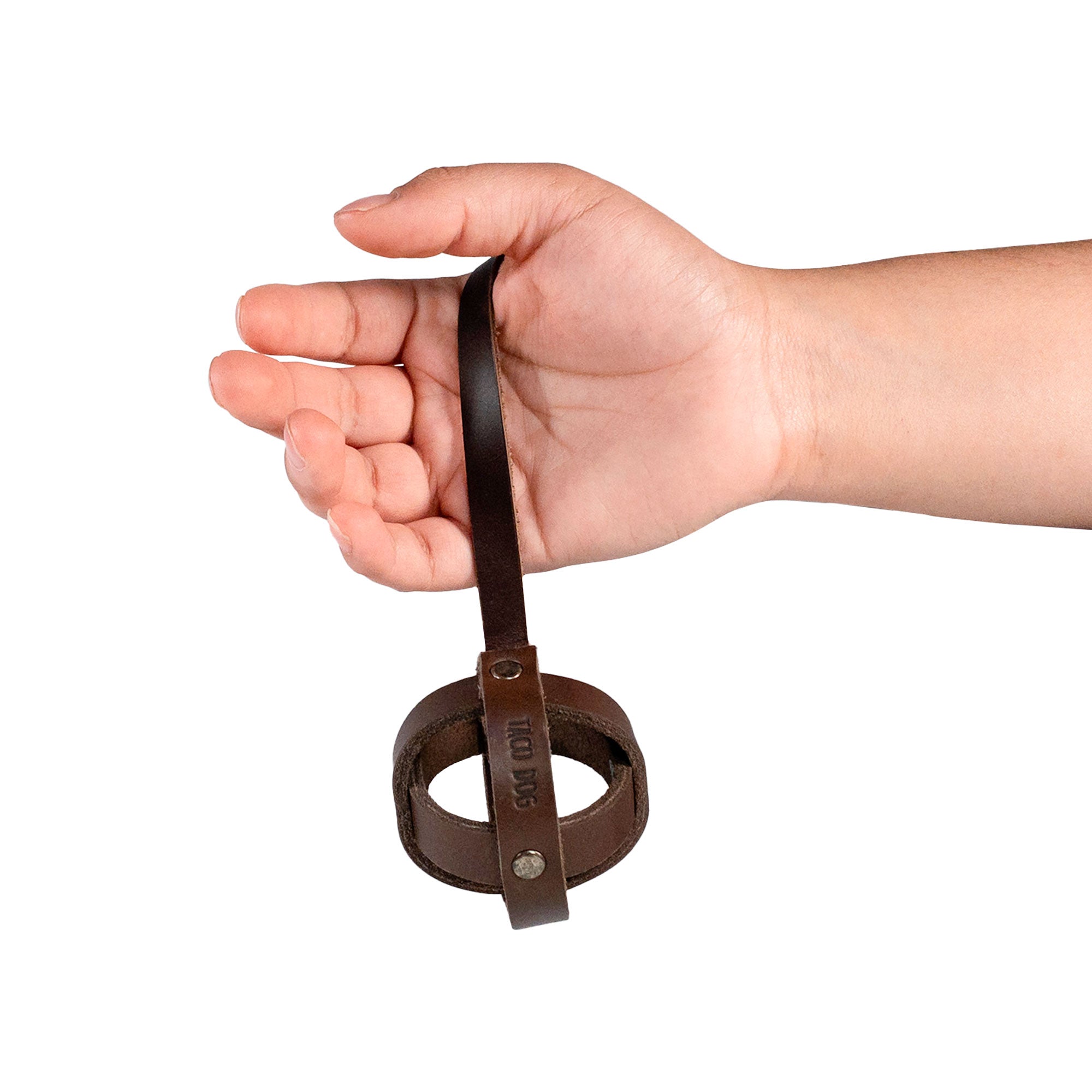 Taco Dog's Ball Toy with Strap for Cats held in a hand, demonstrating the lightweight and durable full grain leather construction. This interactive ball toy serves as a great indoor pet accessory for chasing, made with care in Antigua Guatemala.
