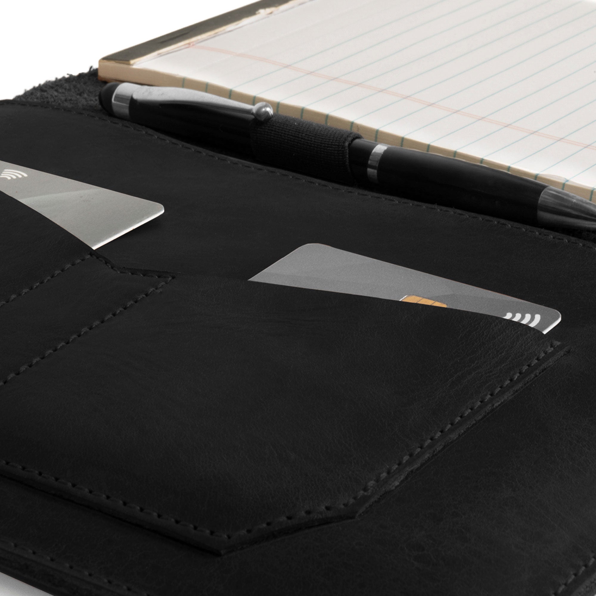 Close-up of the interior of the black Leather Worx Notepad Case 5 x 8 In. featuring a card slot and pen, made from full grain leather. Notepad Cover (5 x 8 In. Notepad Not Included) Sturdy, Durable Material Perfect for Storing Journal, Full Grain Leather, StockyardX, Small Batch Production, Hand Cut, Hand Sewn, Fire Branded, Artisan, Handmade in La Antigua Guatemala & Oaxaca Mexico.