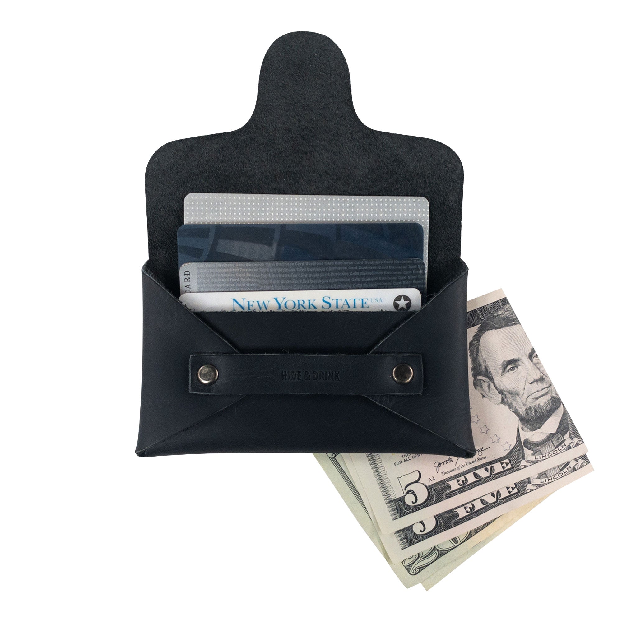 A Snapless Business Card Holder by Hide & Drink, filled with cards and cash, demonstrating its functional design. This stylish vintage wallet for men and women is crafted from durable Full Grain Leather, serving well as a sturdy pouch and money organizer, made with artisan craftsmanship from La Antigua Guatemala and Oaxaca Mexico.