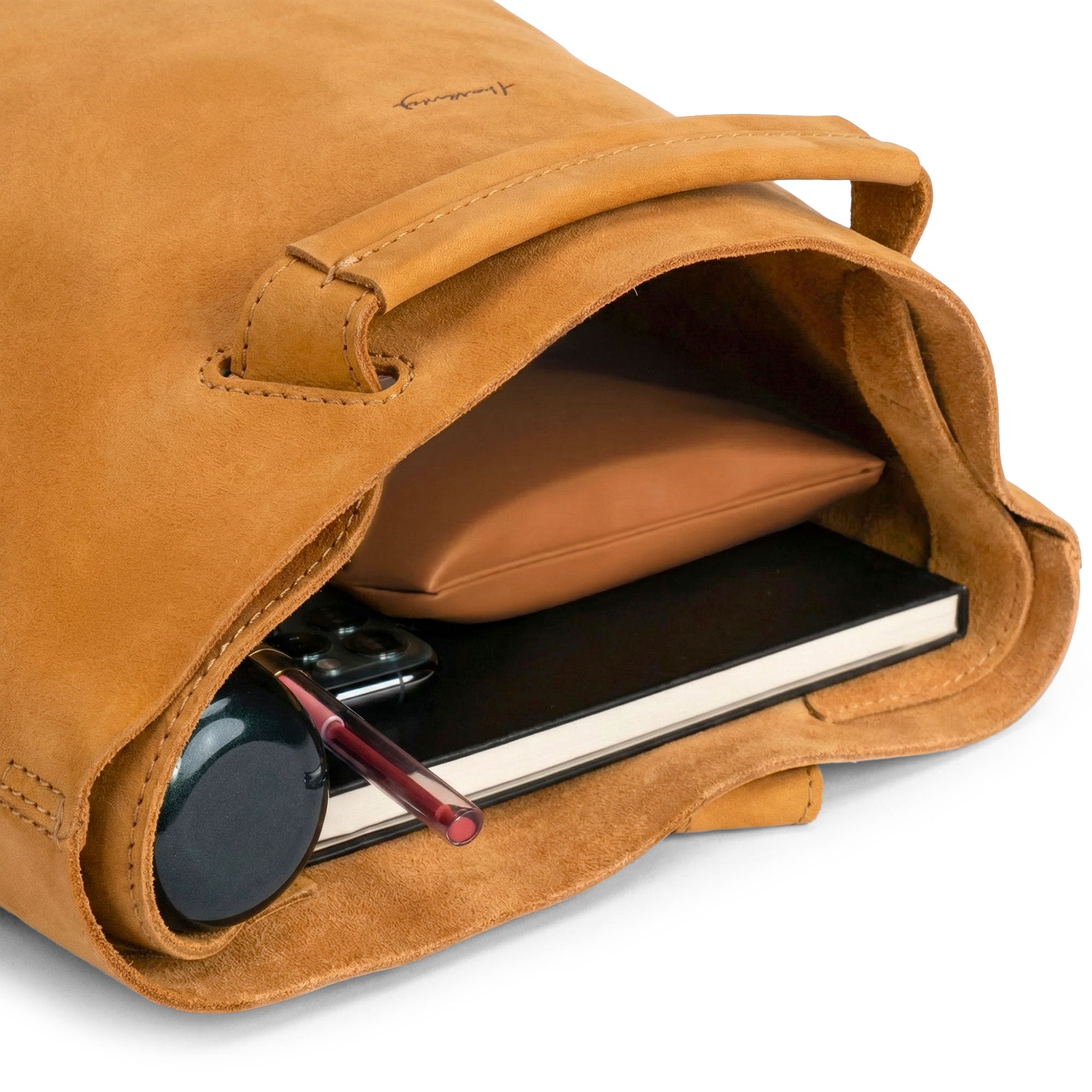 Interior view of the Convertible Backpack to Shoulder Bag by Heather's, displaying the spacious design for everyday essentials. This bag is crafted from Full Grain Leather and reflects the artistry of small batch production with hand cut and hand sewn details. Handmade in La Antigua Guatemala & Oaxaca Mexico.