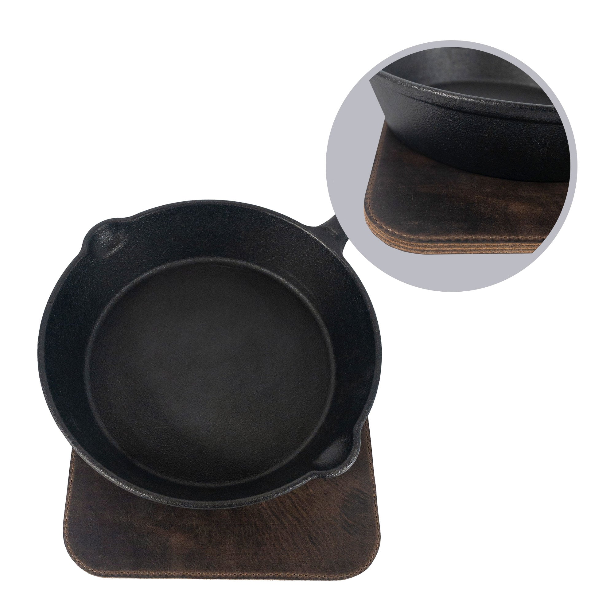 A Cast Leather Co. Leather Oven Mitt & Trivet positioned underneath a hot cast iron dish, demonstrating its use as a practical hot pot pad (potholder). Crafted from full grain leather, this heat-resistant product is a testament to small batch production and artisan skills, handmade in La Antigua Guatemala.